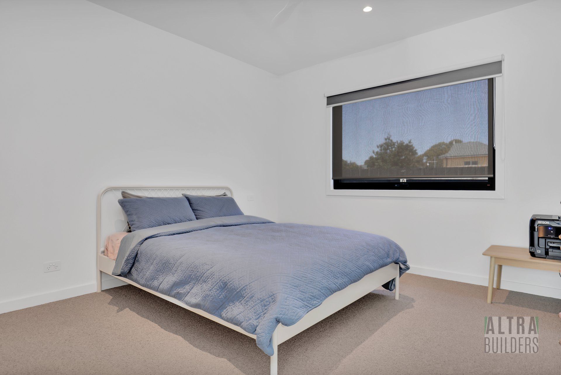 A bedroom with a large bed and a window