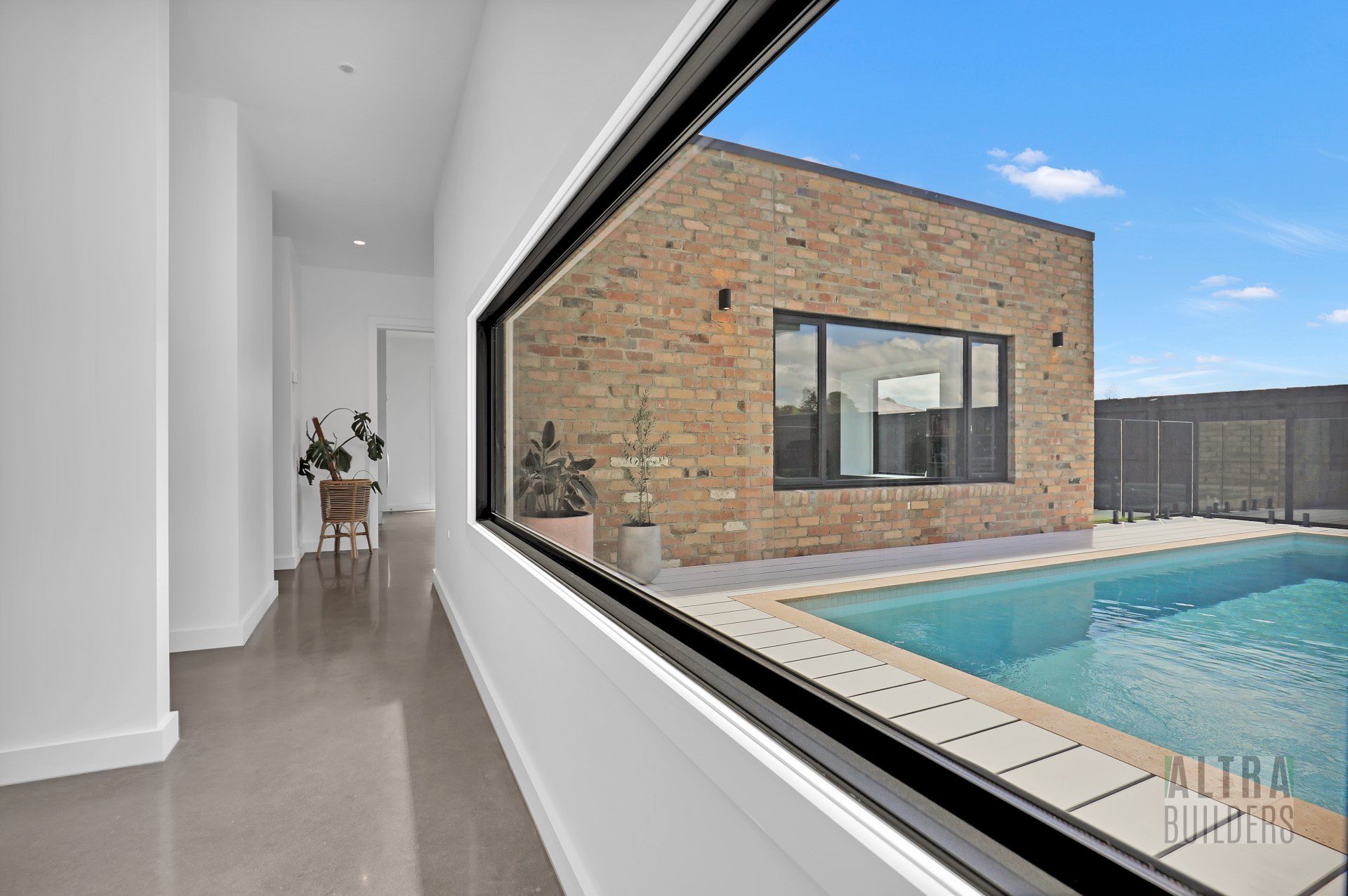 A view of a house with a pool through a window