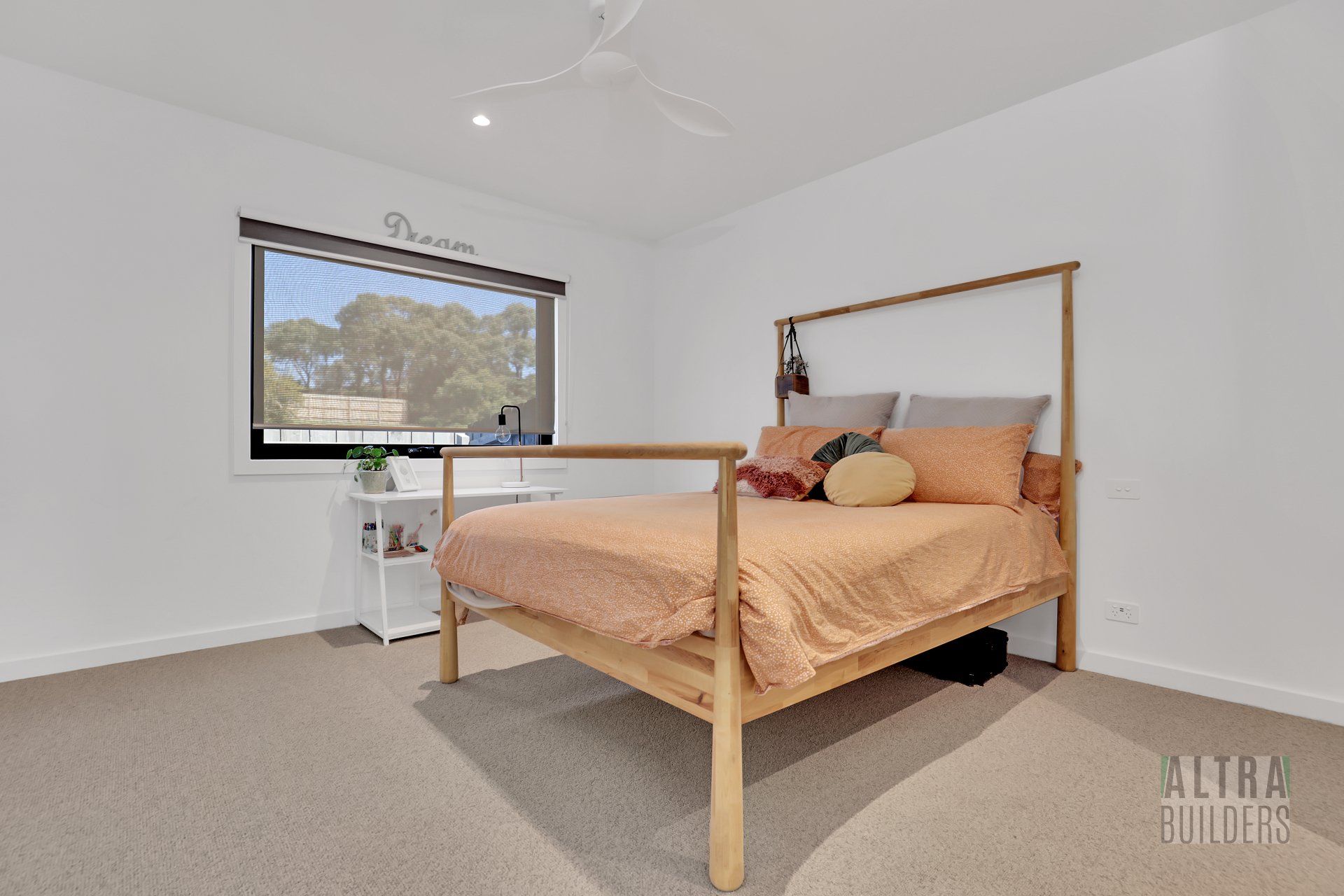 A bedroom with a large bed and a window.