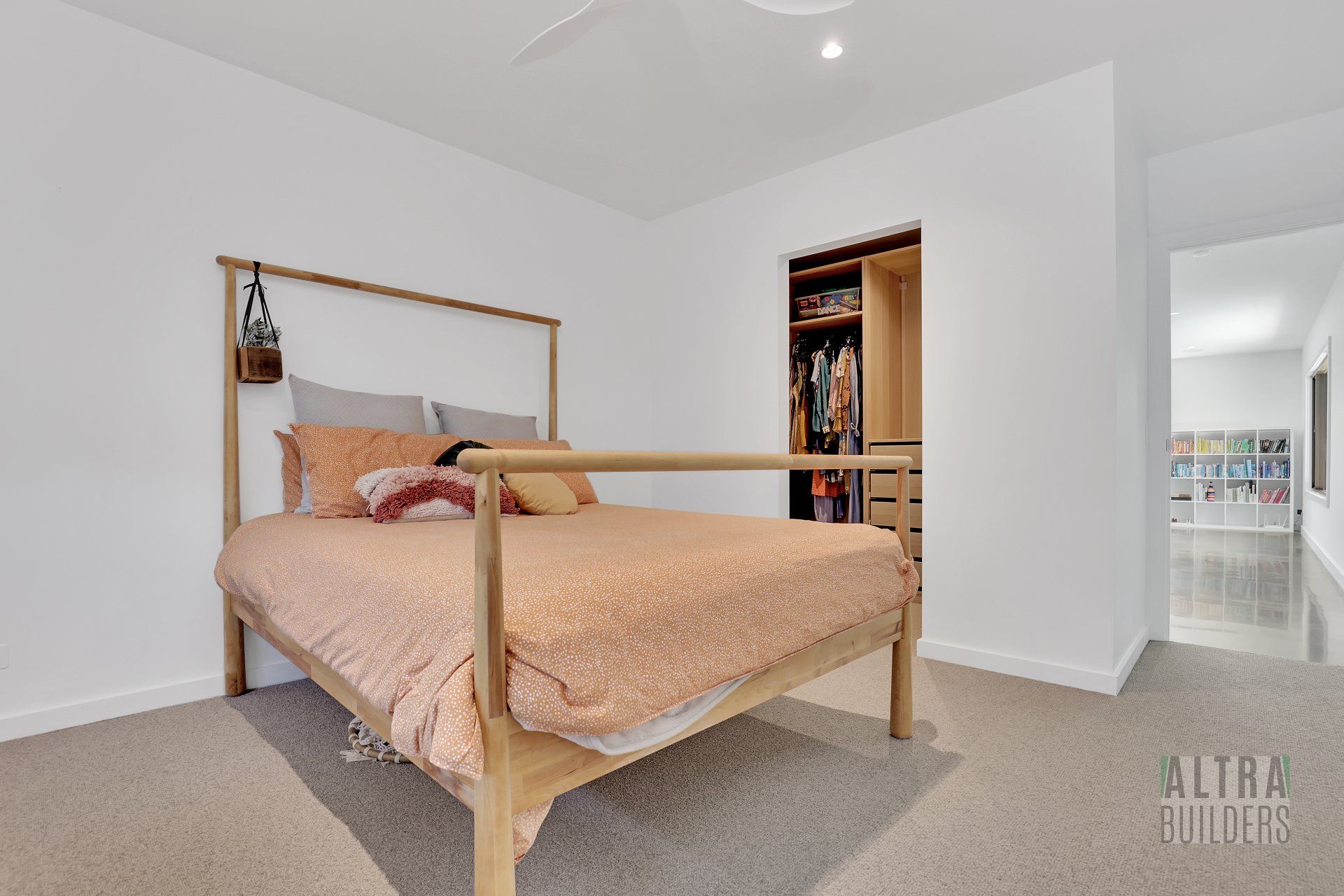 A bedroom with a bed and a walk in closet