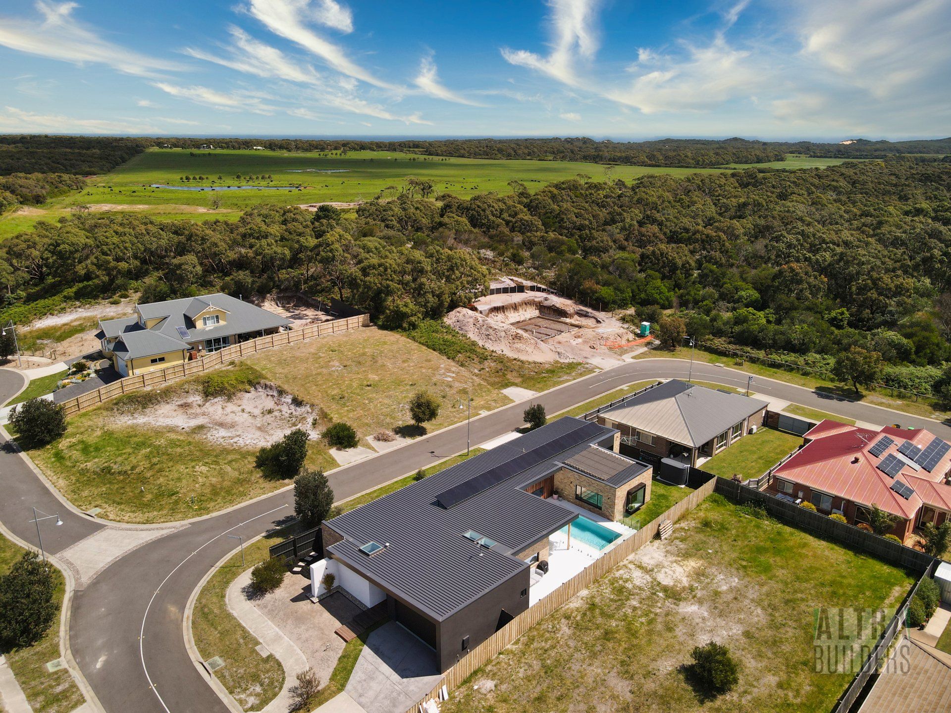 An aerial view of a residential area with houses and trees