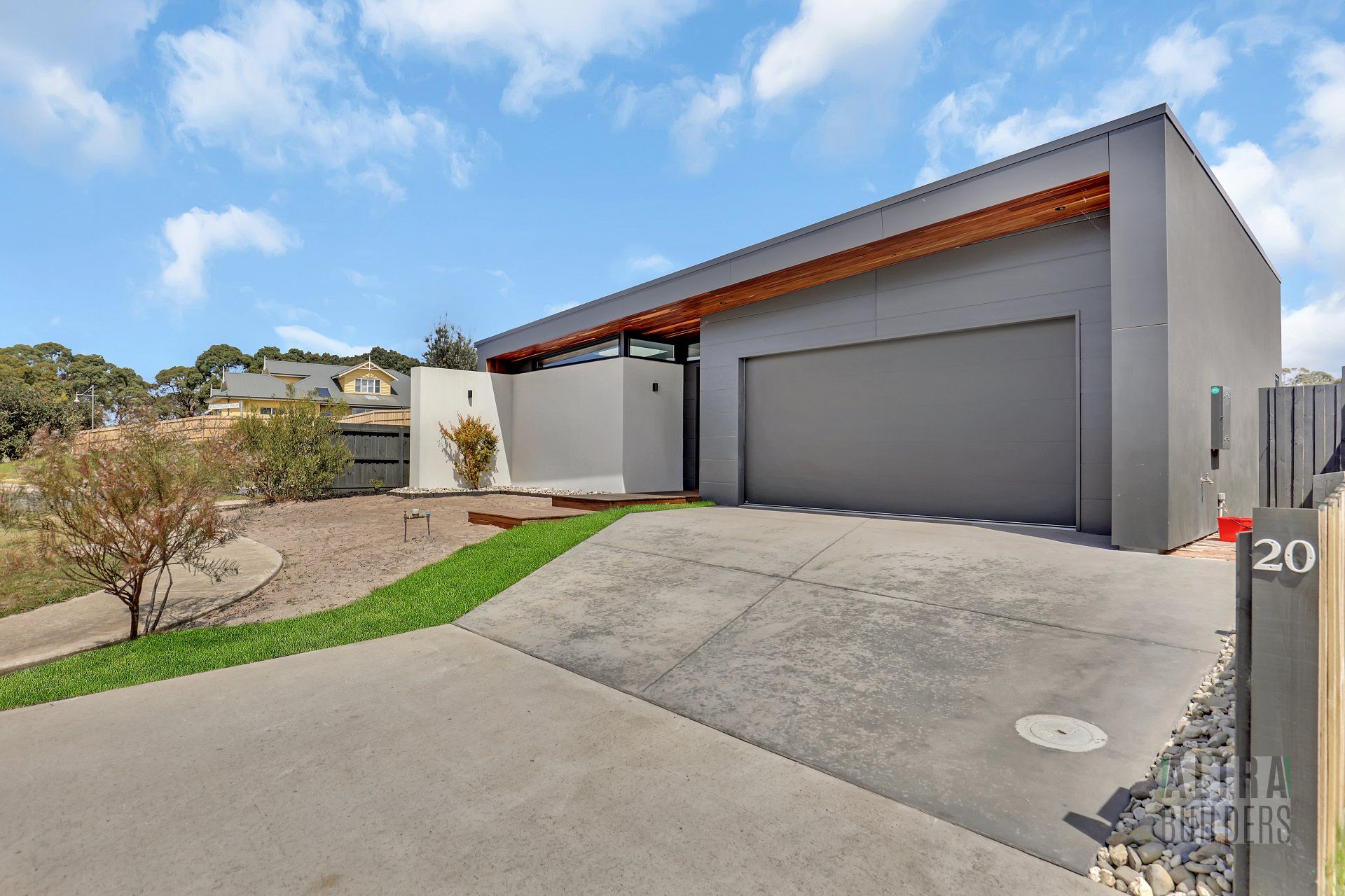 A modern house with a large garage and a driveway