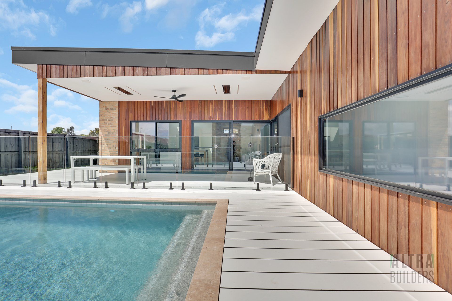 A house with a swimming pool in front of it