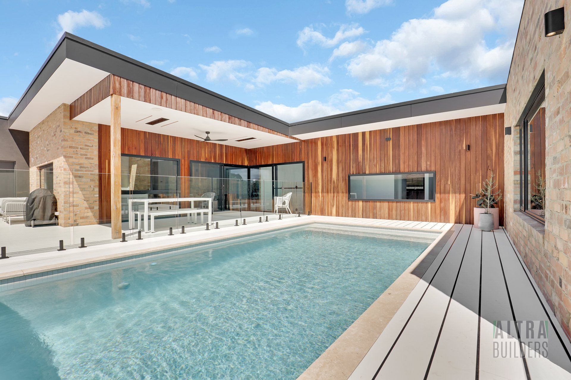 A large house with a swimming pool in front of it