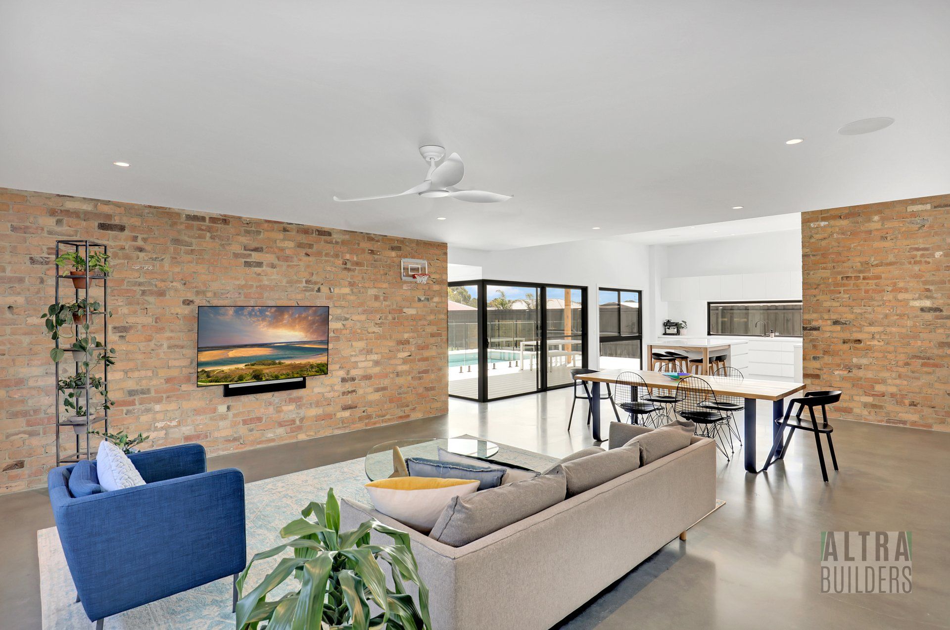 A living room with a couch , chairs , table and television.