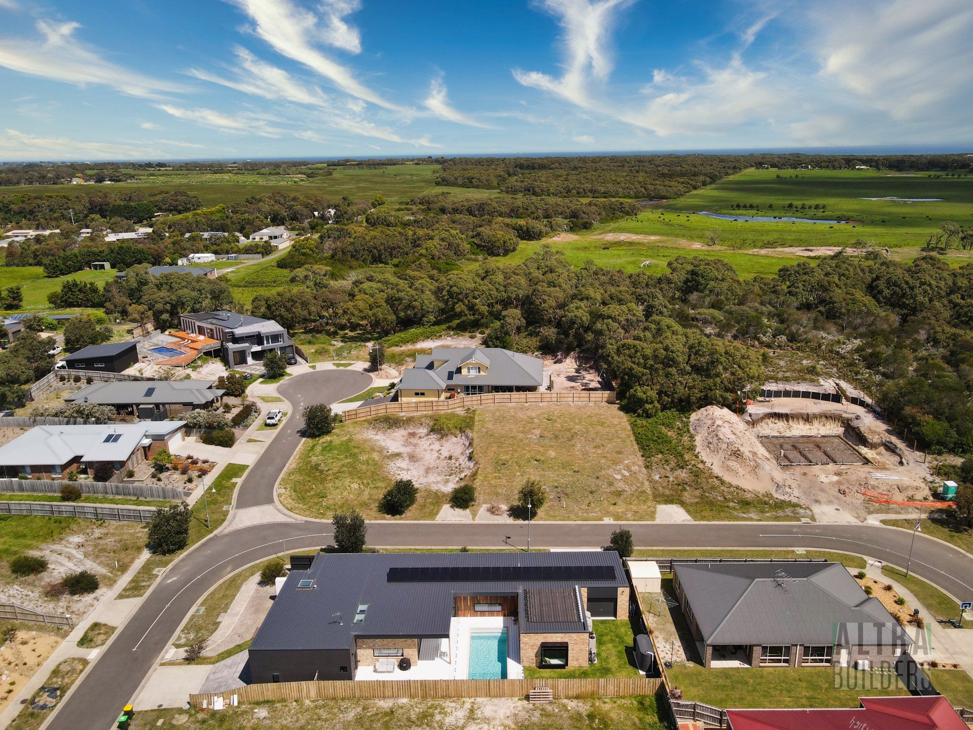 An aerial view of a residential area with lots of houses and trees.