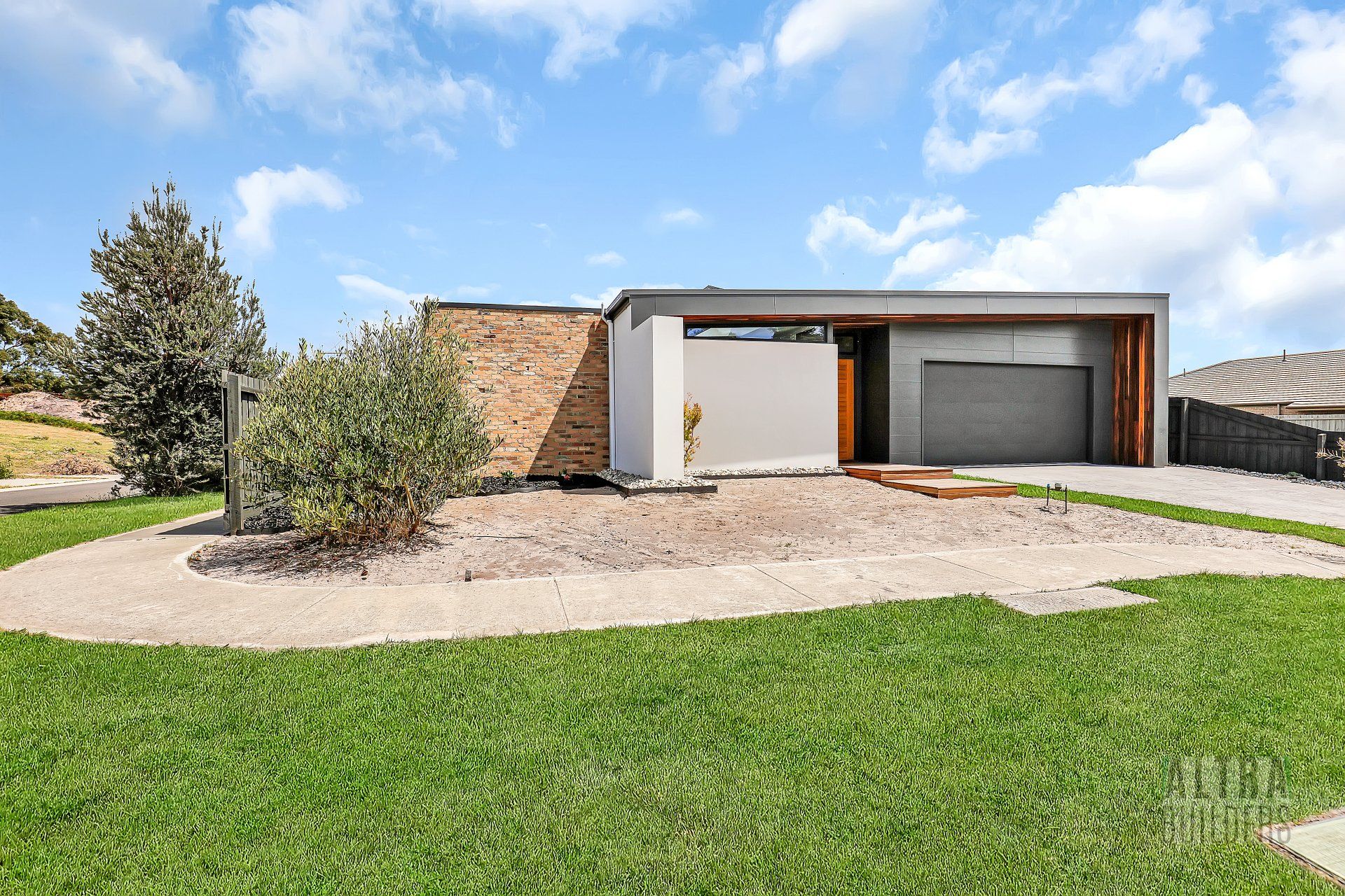 A modern house with a large lawn in front of it