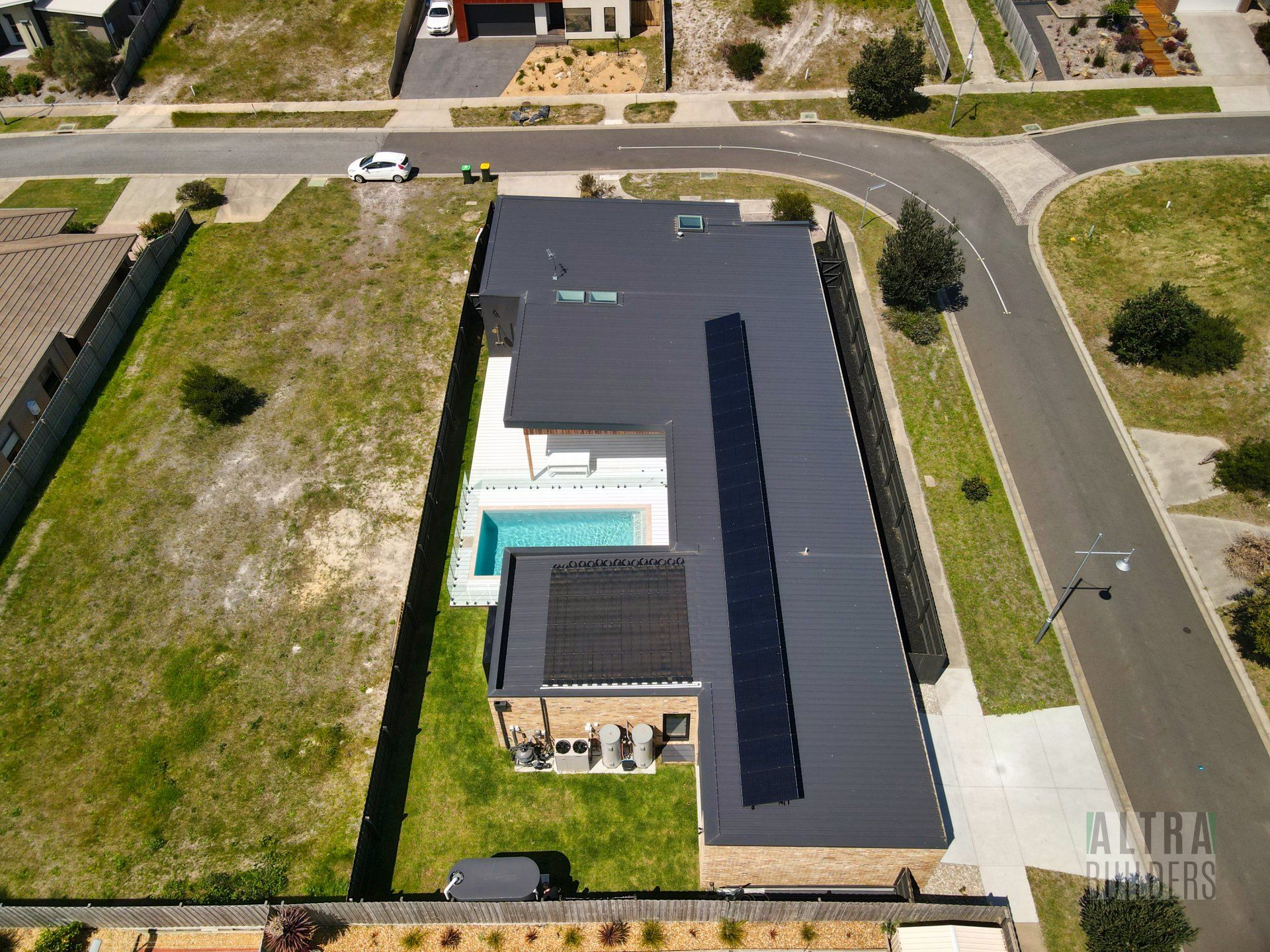 An aerial view of a house with solar panels on the roof