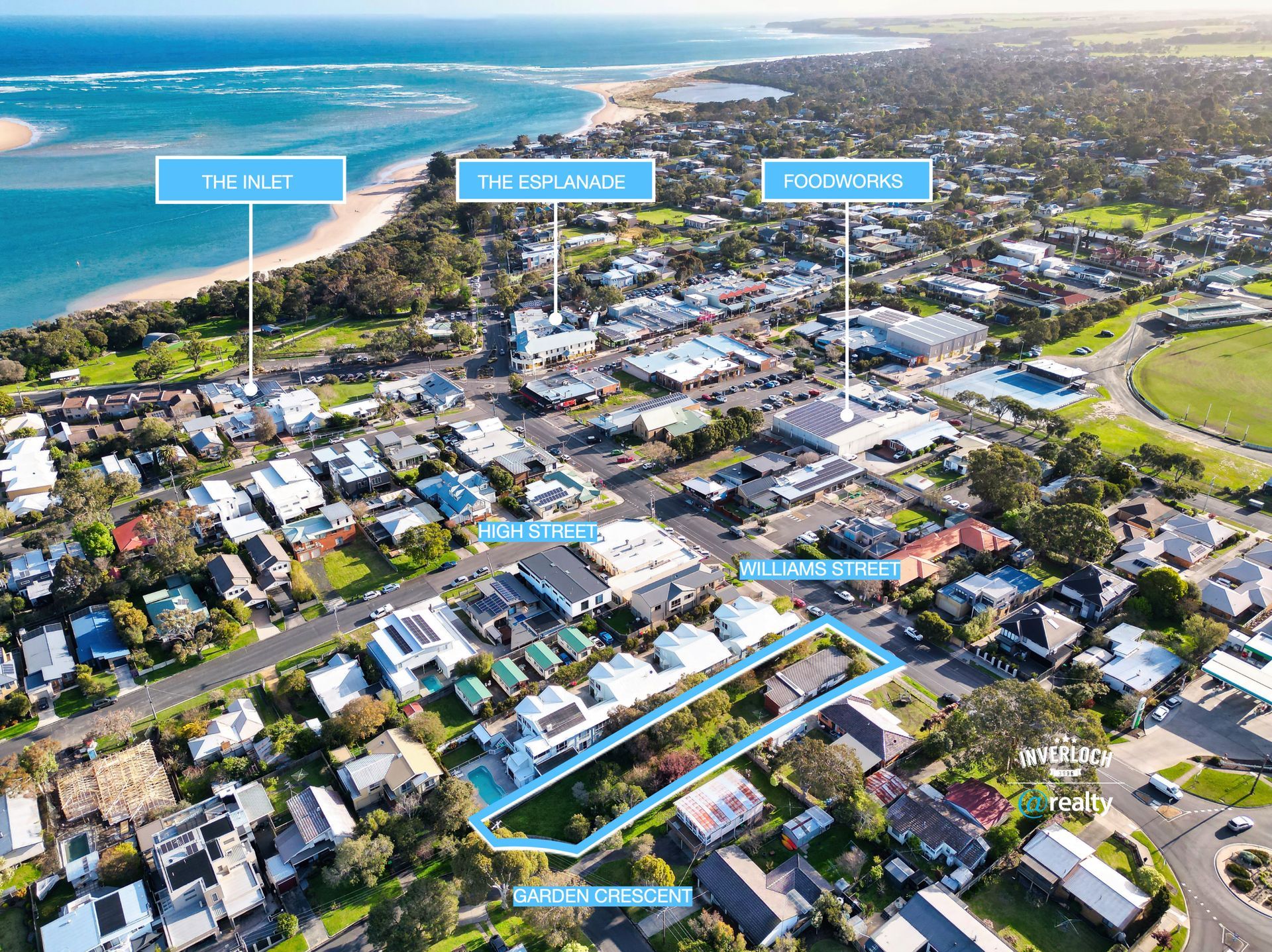 Aerial view of a coastal town, with buildings, streets, and labels pointing to businesses near the ocean.