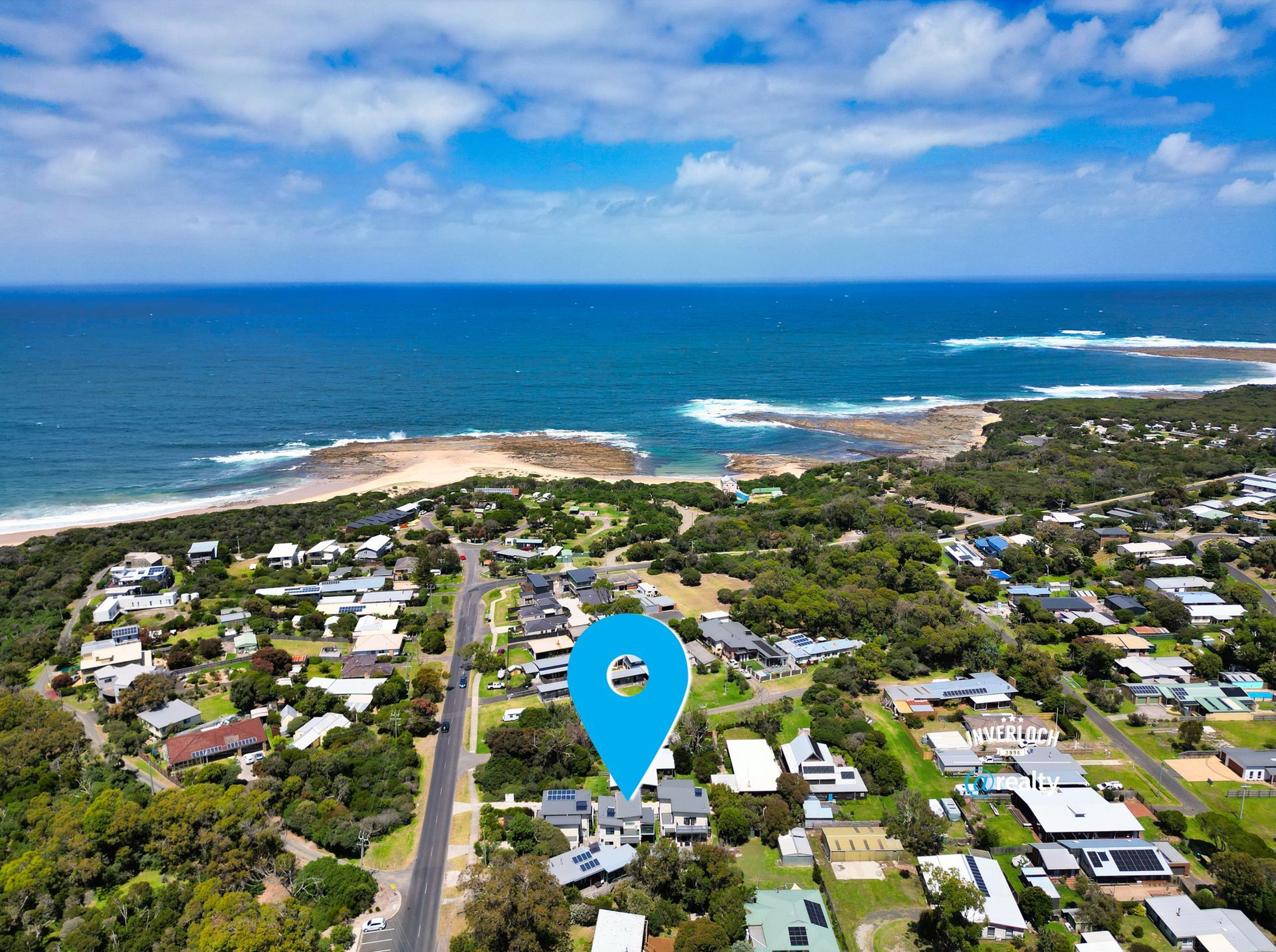 An aerial view of a residential area next to the ocean. 