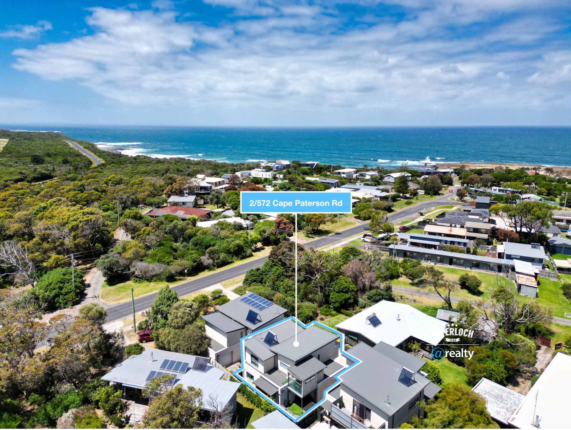 An aerial view of a residential area near the ocean.