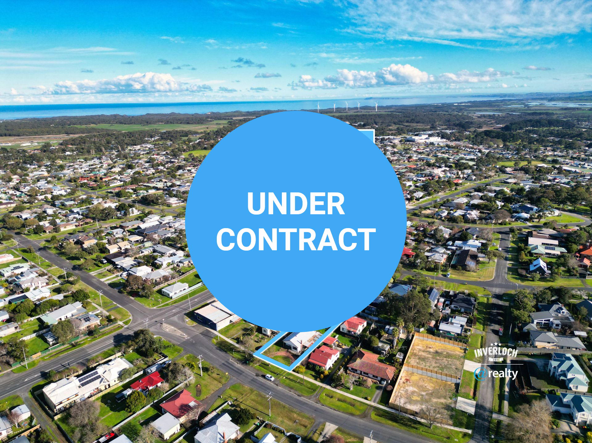 Aerial view of a residential area with a property marked at 26 Beach Rd, featuring houses, roads, and the sea.