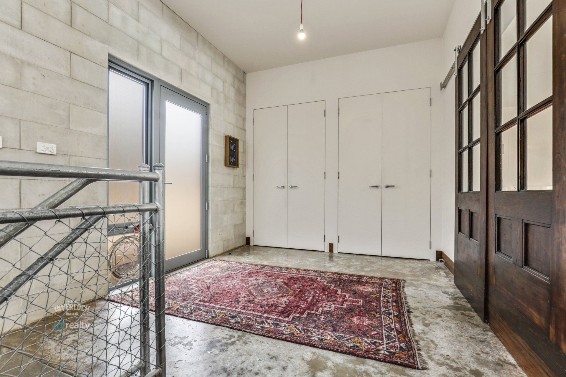 There is a rug on the floor in the middle of the room.