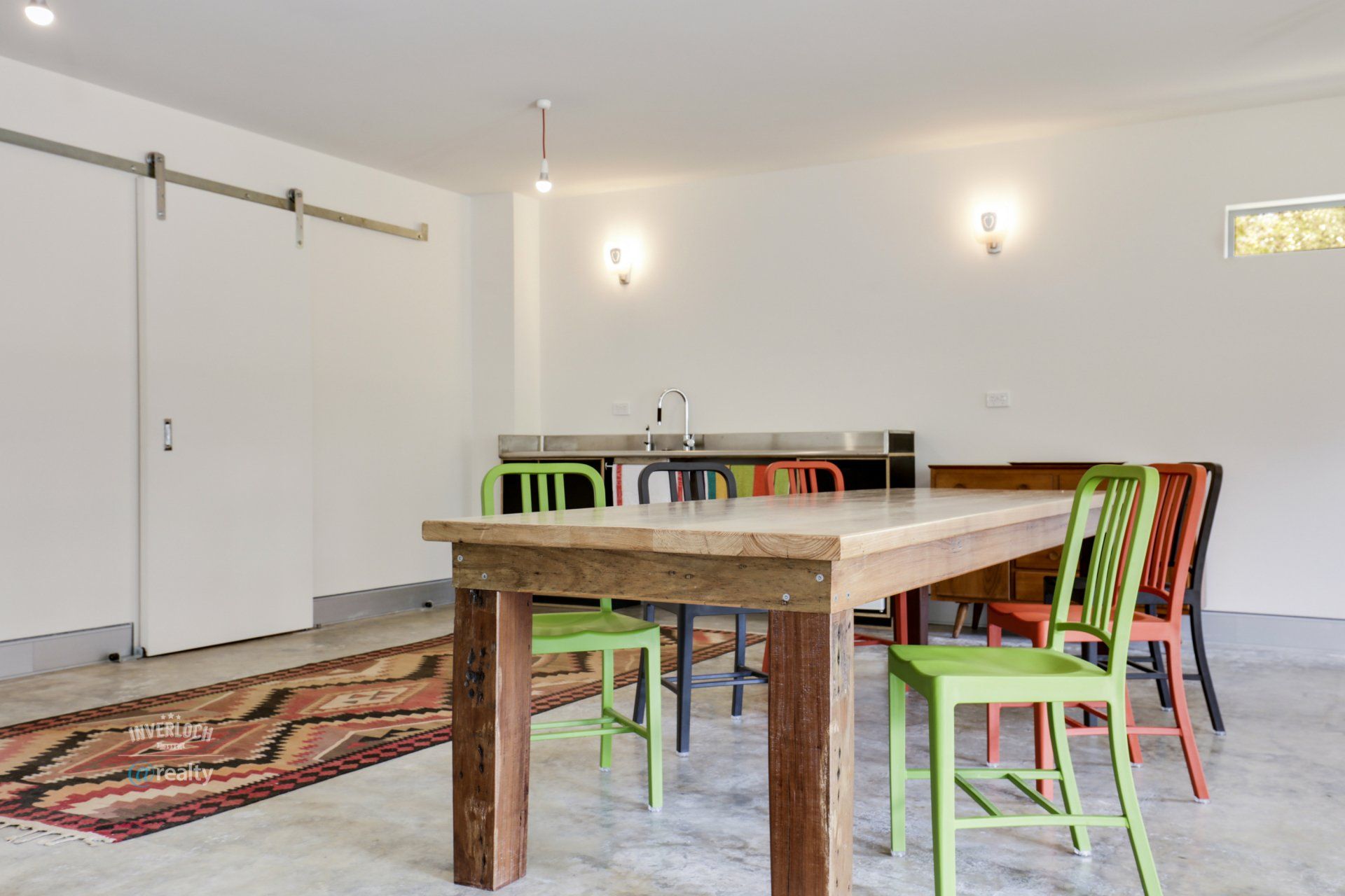 A room with a table and chairs in it