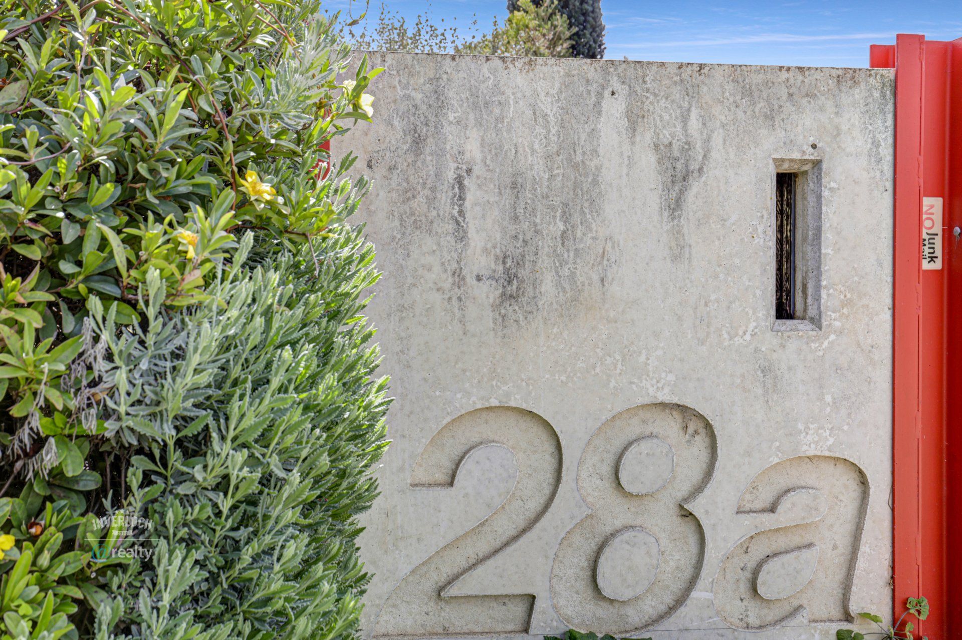 A concrete wall with the number 28a carved into it