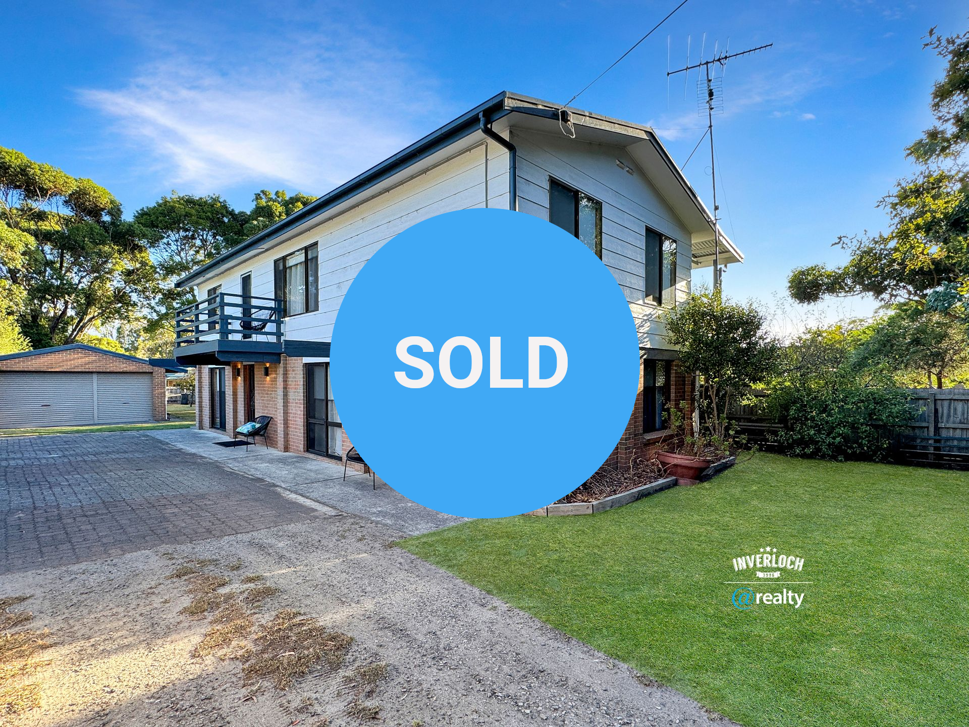 A large house with a lot of windows and a lot of grass in front of it.