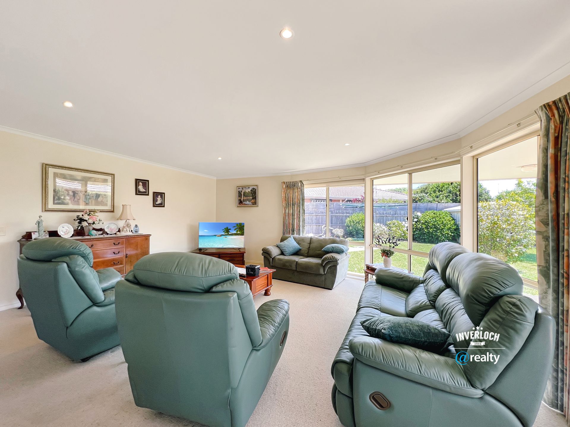 A living room filled with furniture and a television.