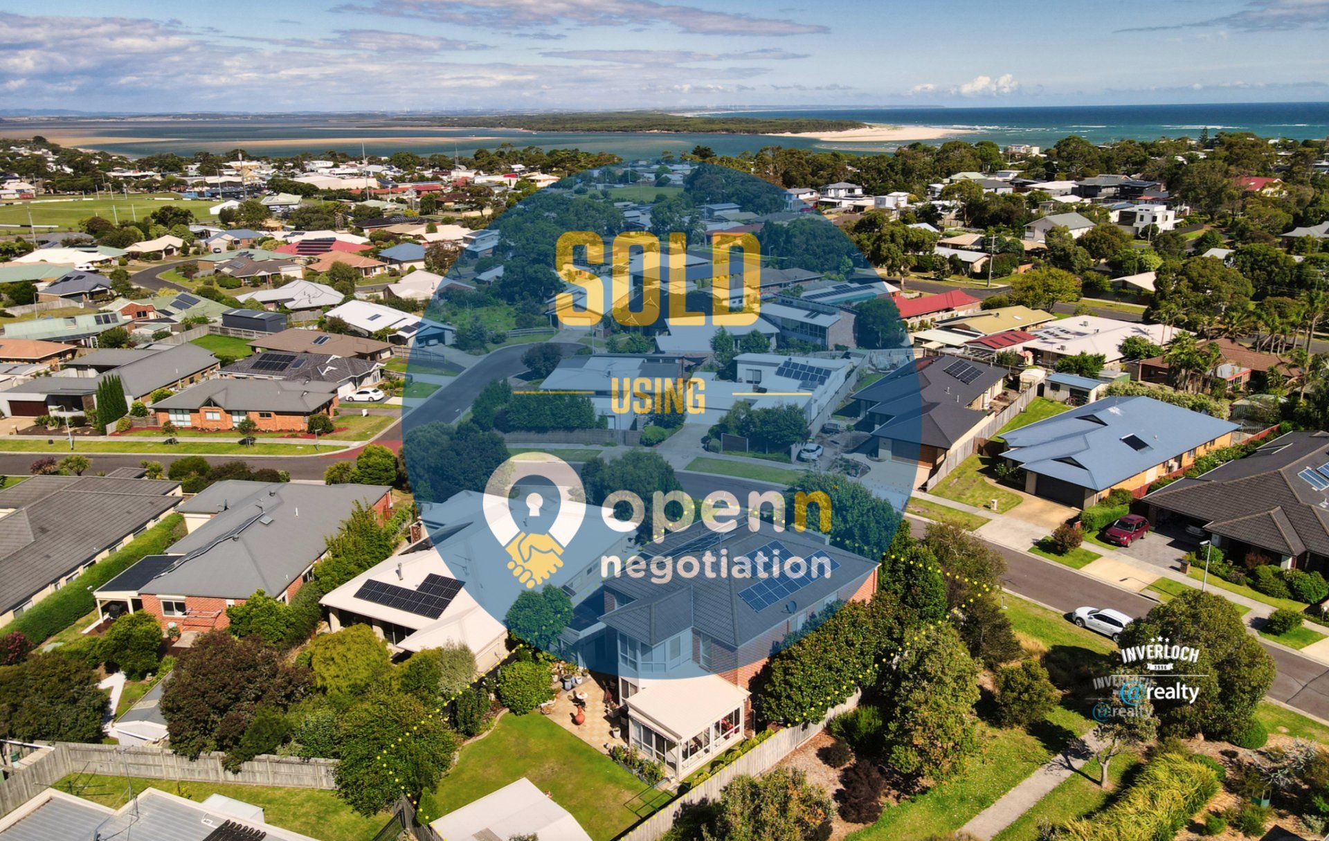 An aerial view of a residential area with a sold sign in the foreground.