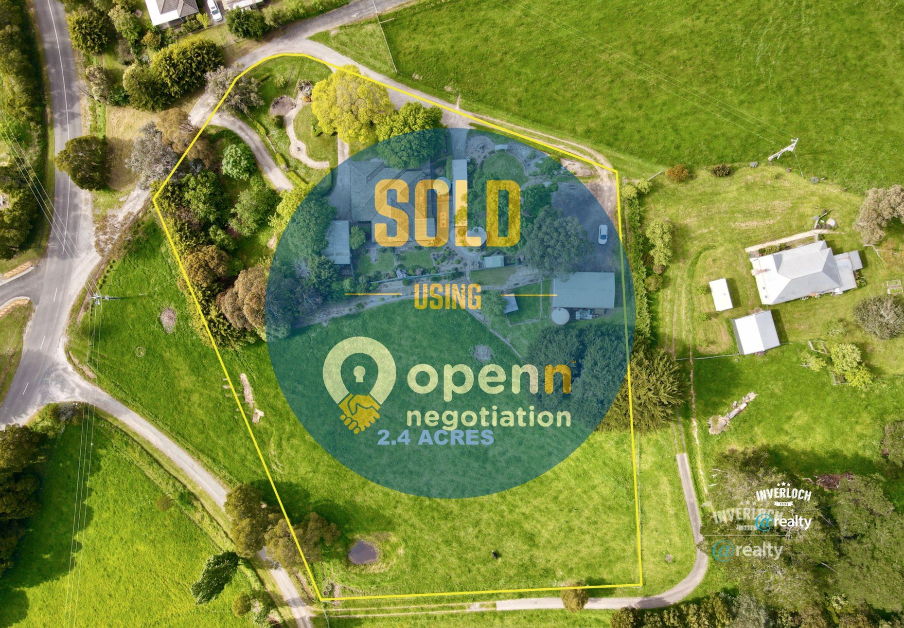 An aerial view of a field with a sign that says `` sold using openn negotiation ''.