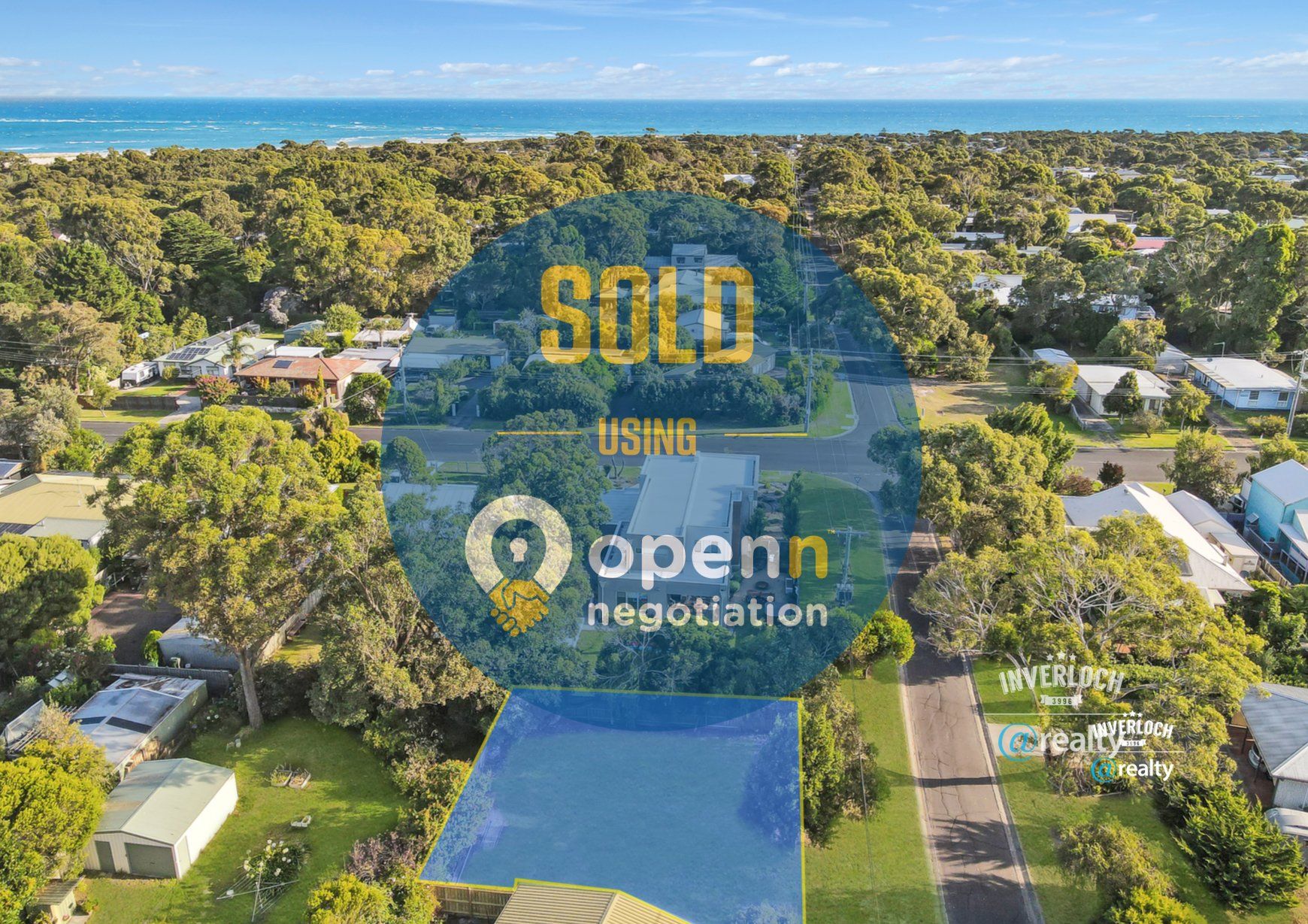 An aerial view of a residential area with a sold sign in the foreground.