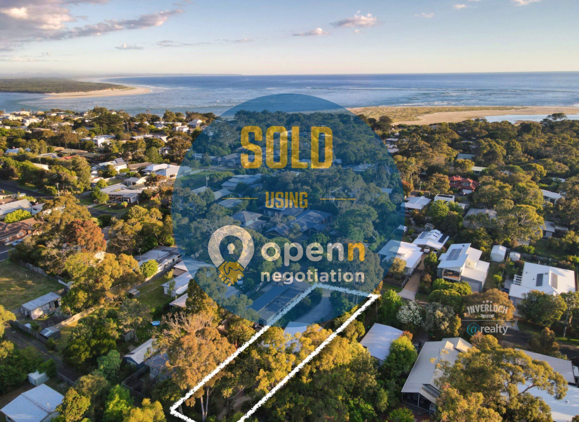An aerial view of a residential area with a sign that says sold