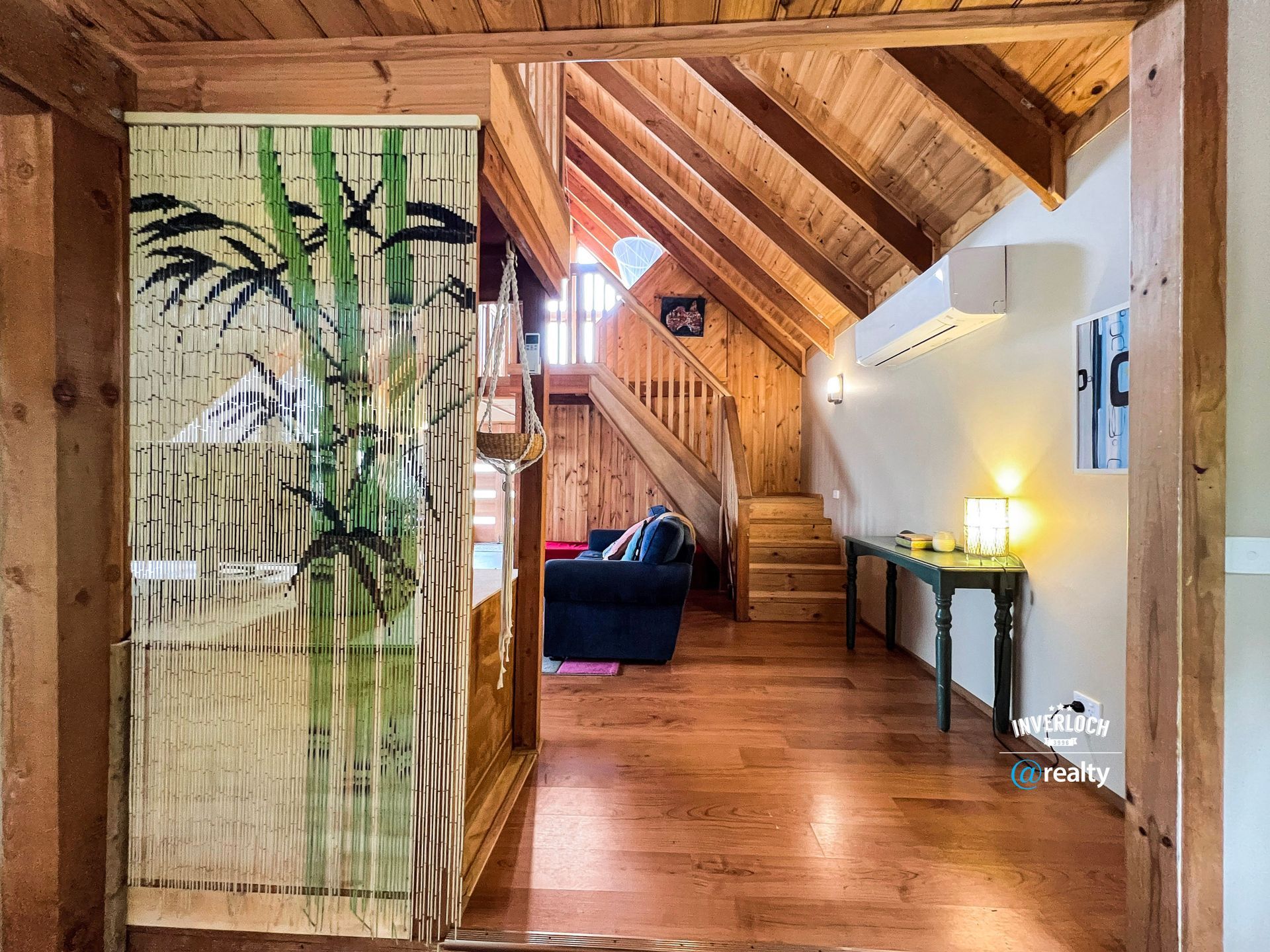 A wooden house with a staircase leading up to the second floor