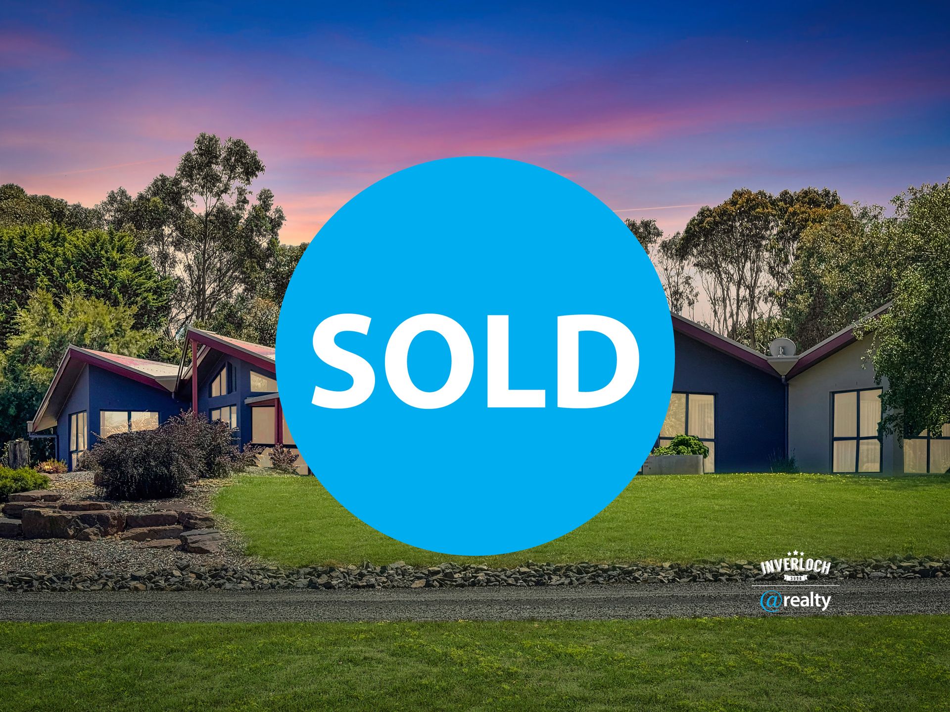 House with blue exterior, grassy lawn. Large blue 