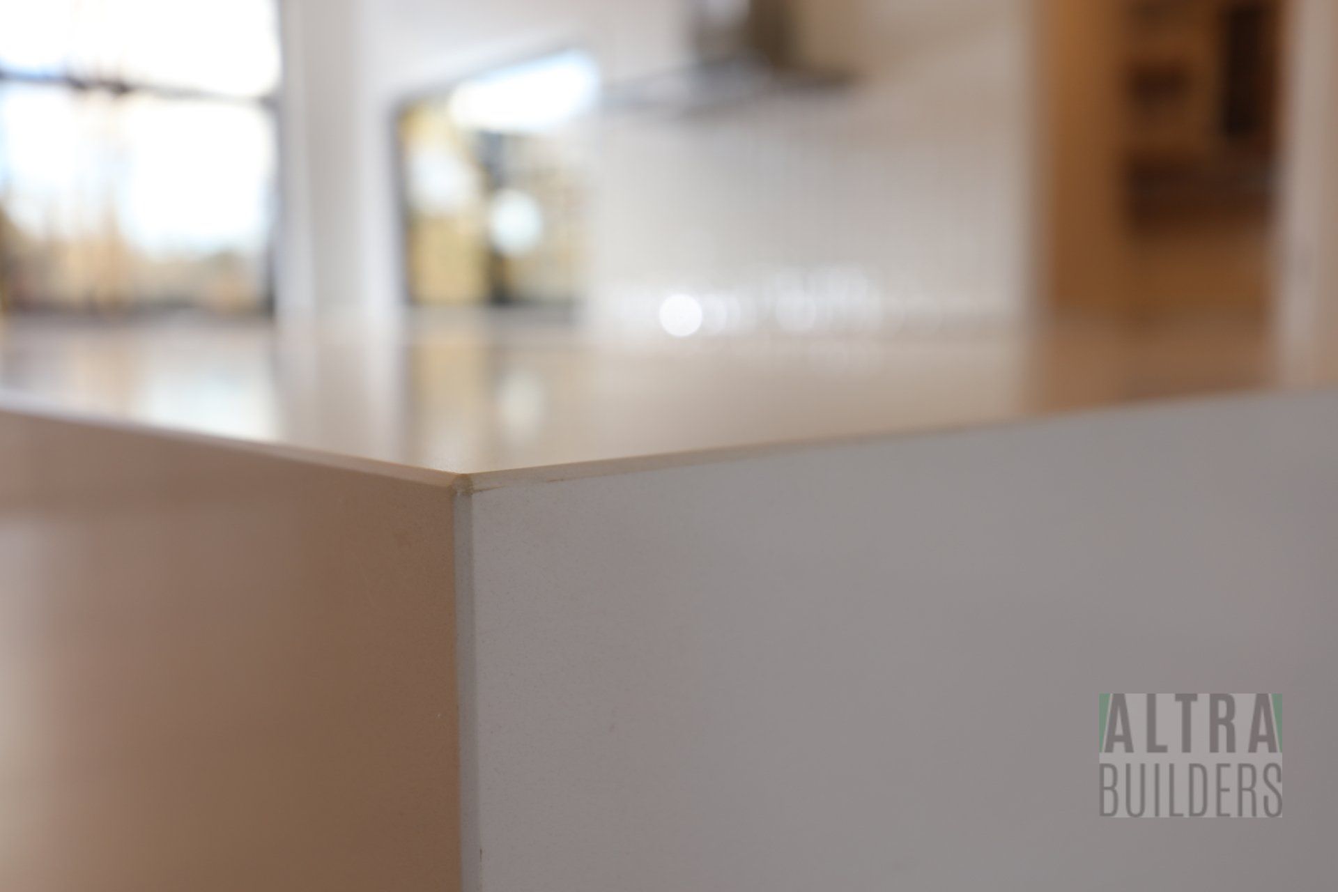 A white counter top with the word altra builders on it