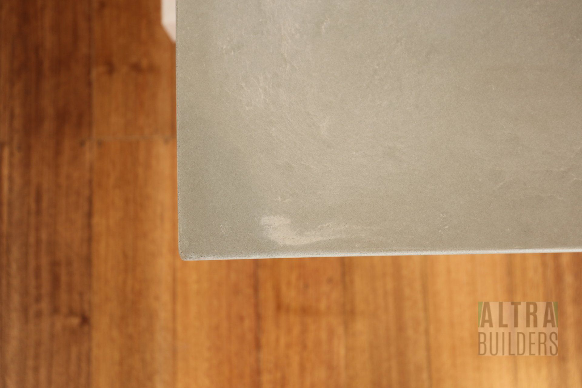 A piece of concrete is sitting on top of a wooden floor.