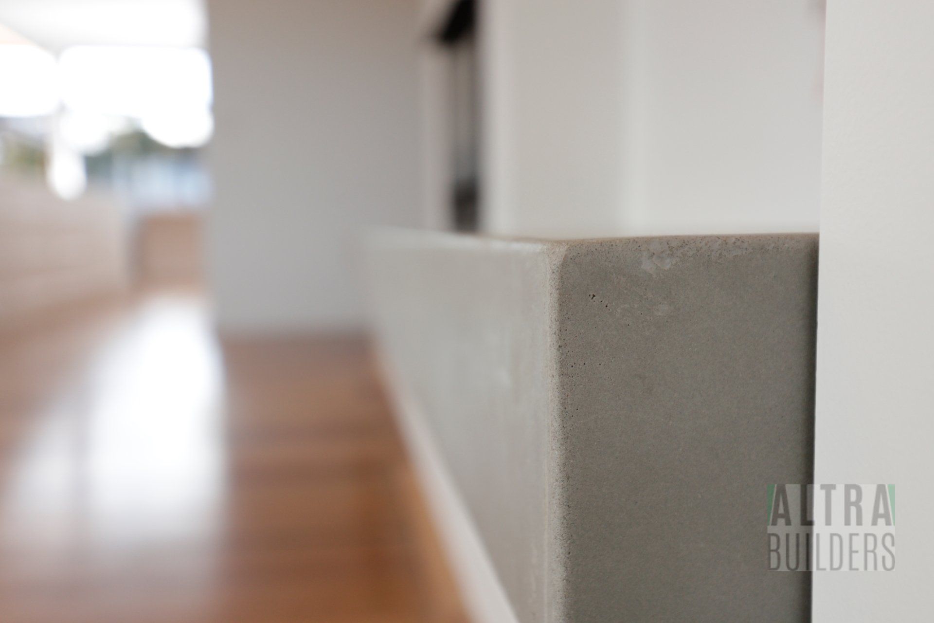 A corner of a wall with the word altra builders on it