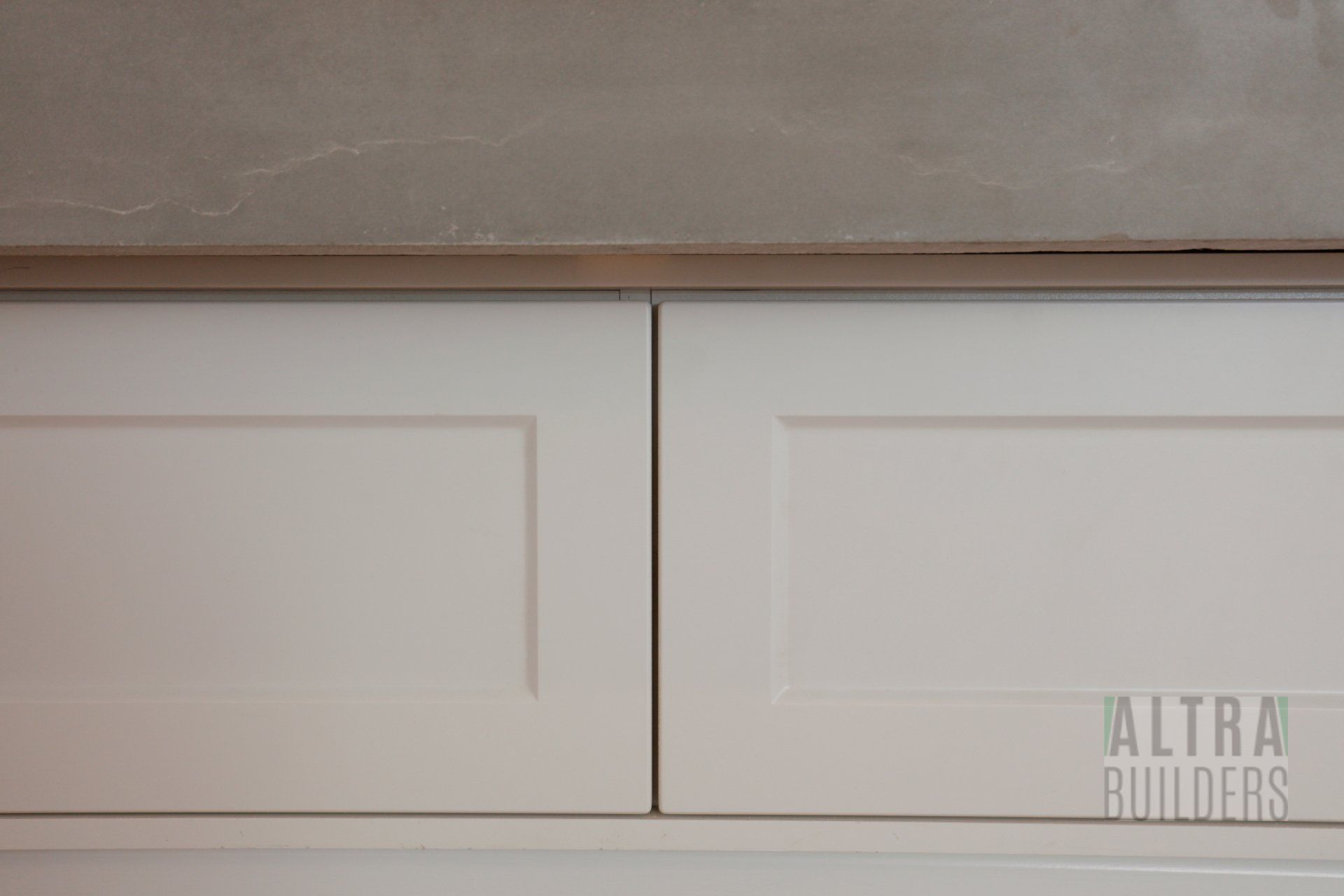 A close up of a white cabinet with the word builders on the bottom.