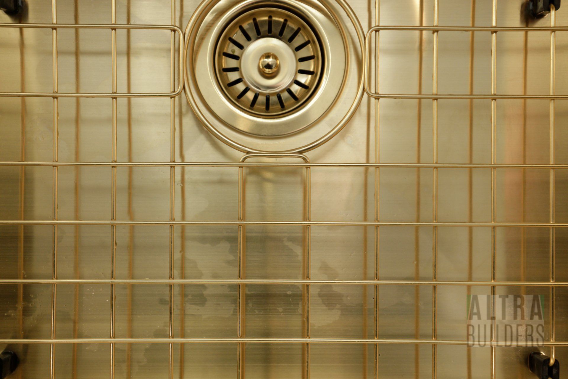 A close up of a stainless steel sink with a drain