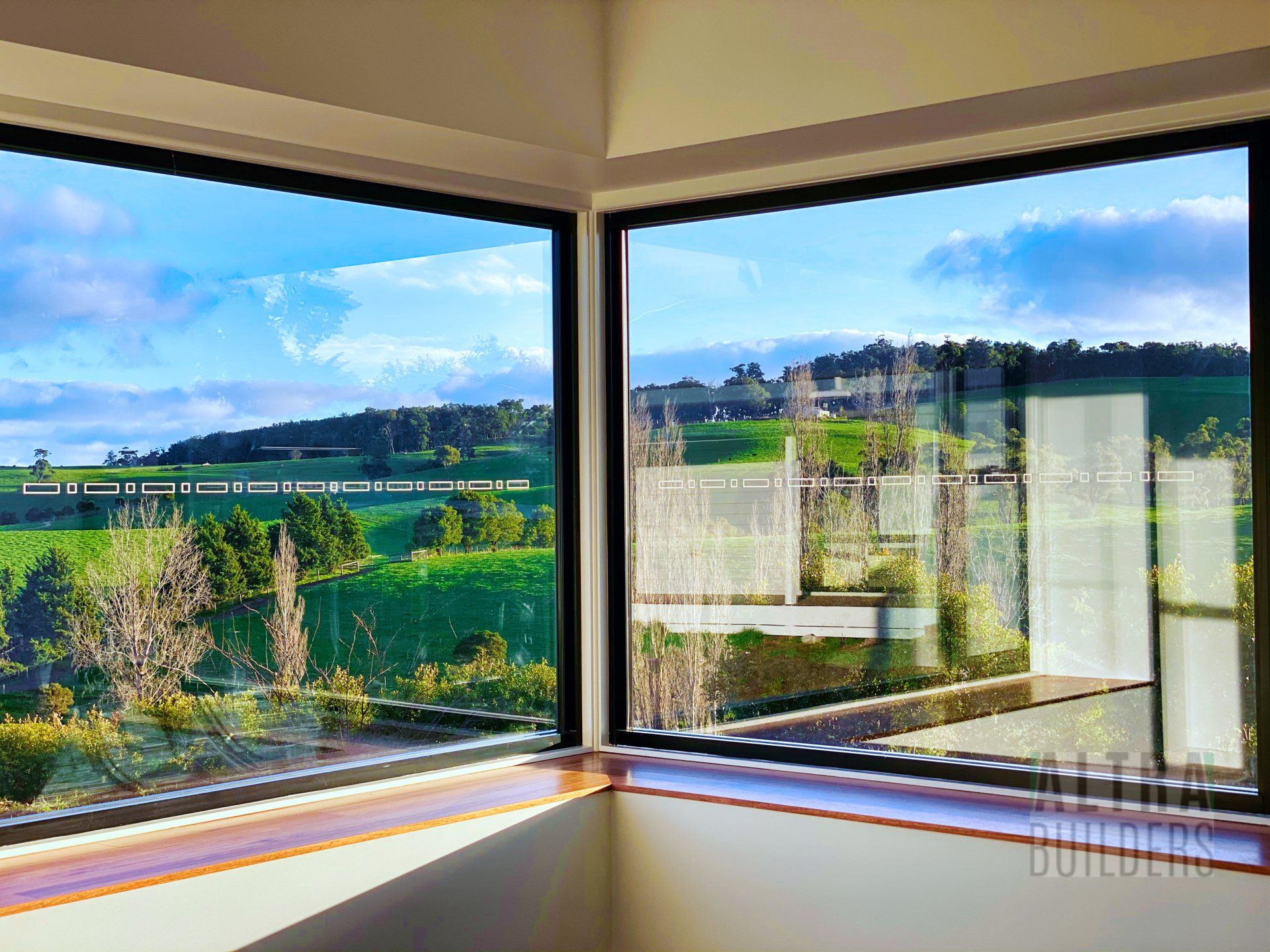 A large window with a view of a field and trees