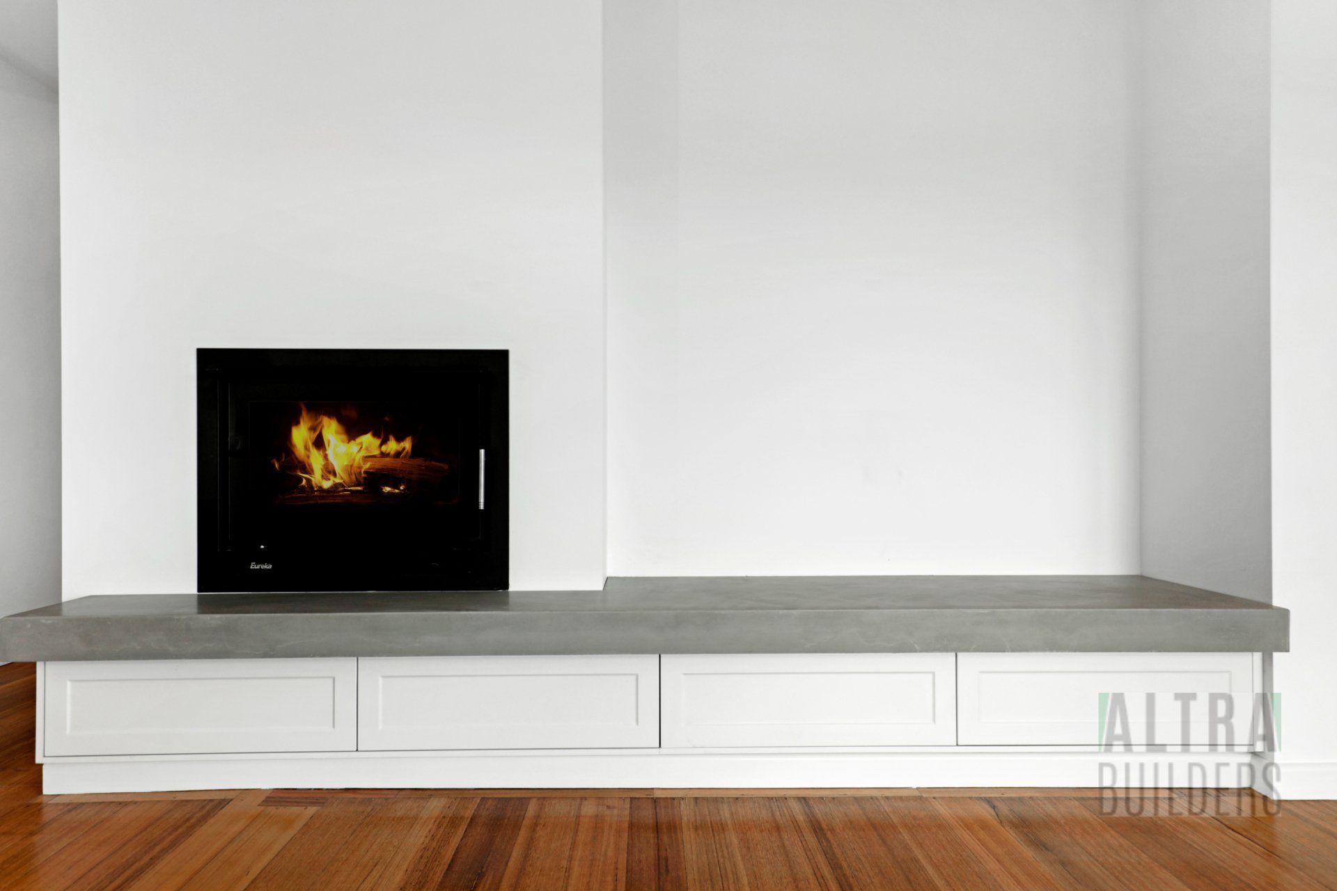 There is a fireplace in the corner of the room.