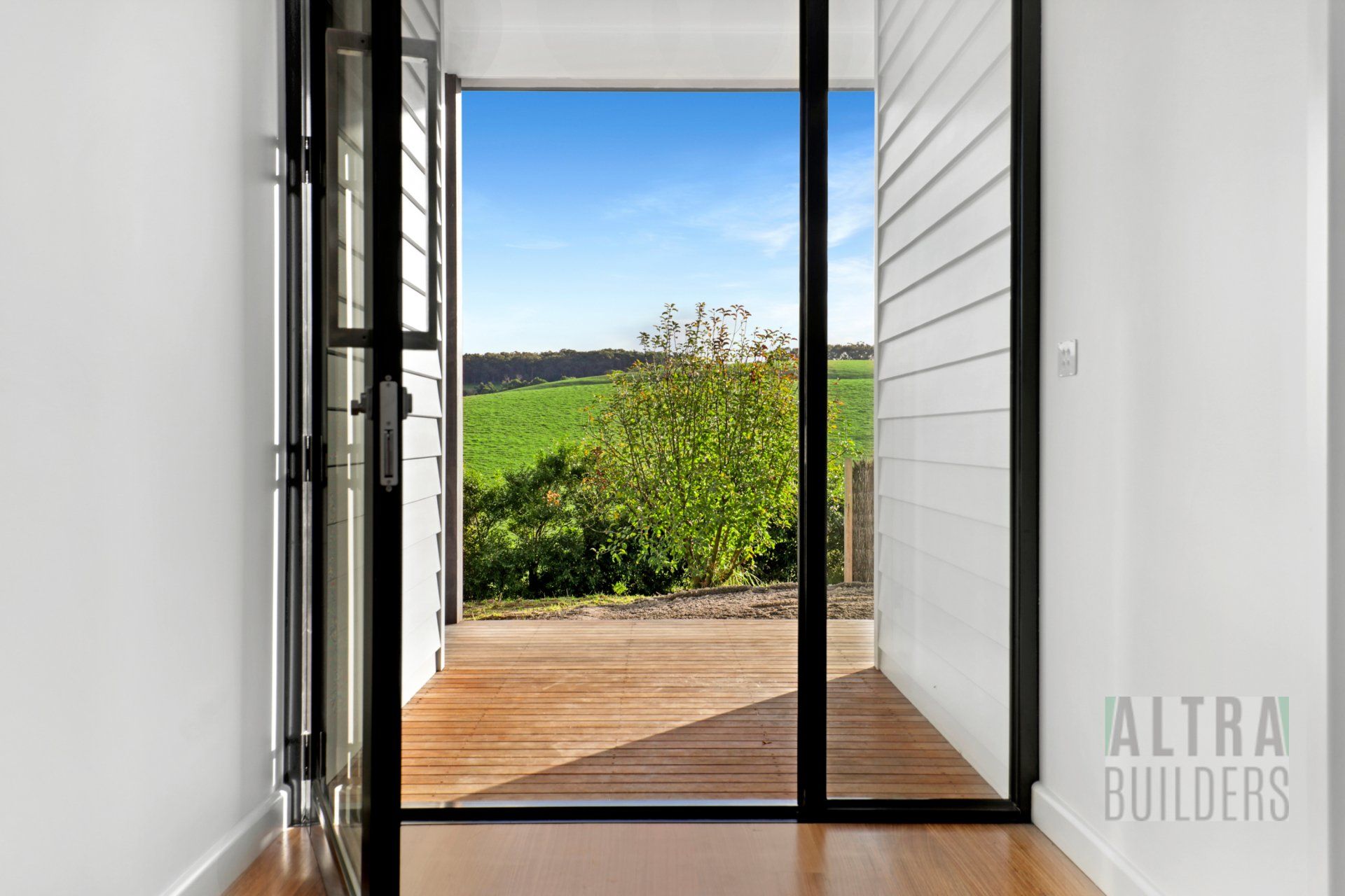 A room with a sliding glass door leading to a deck