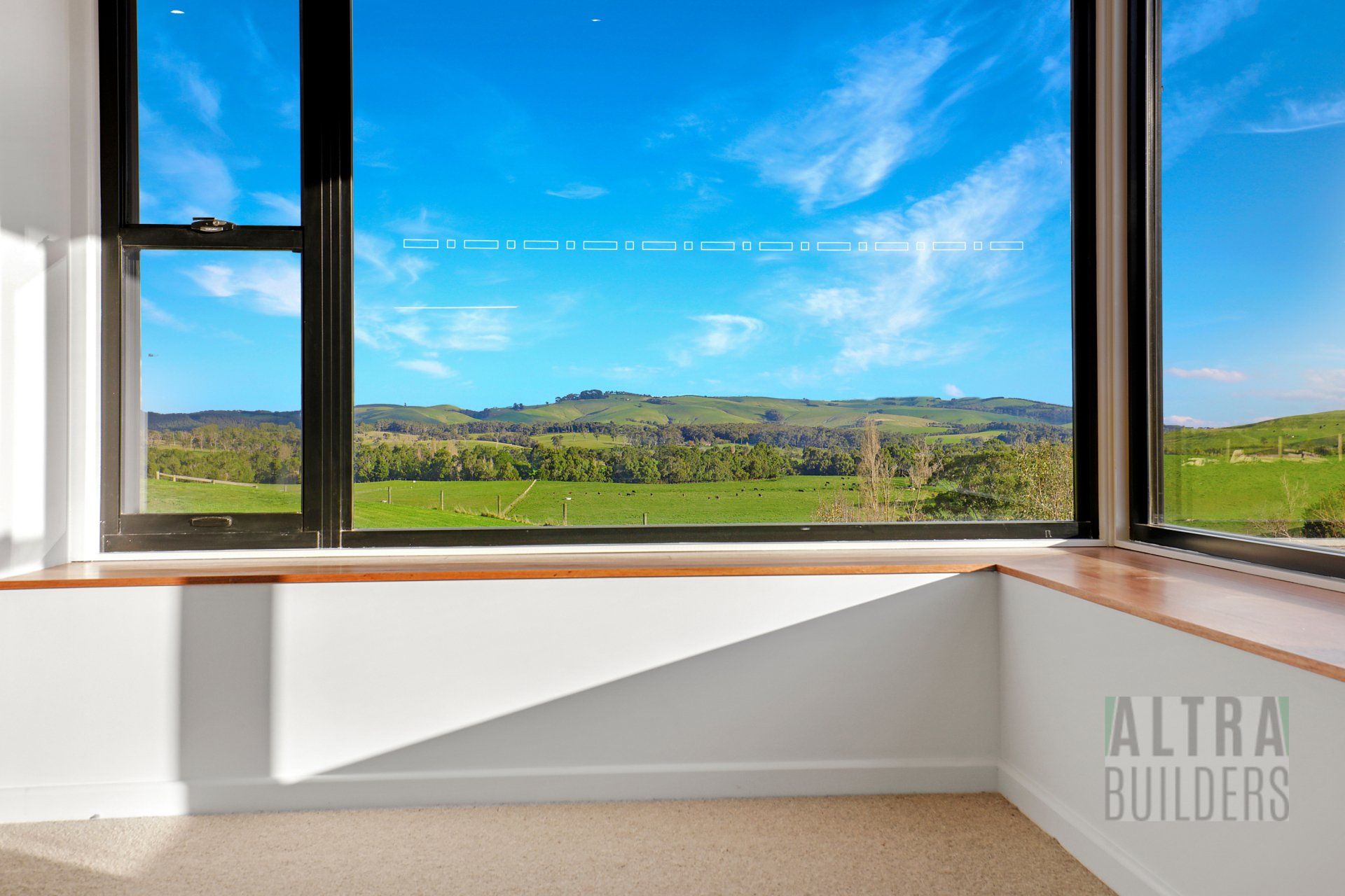 There is a large window with a view of a field.