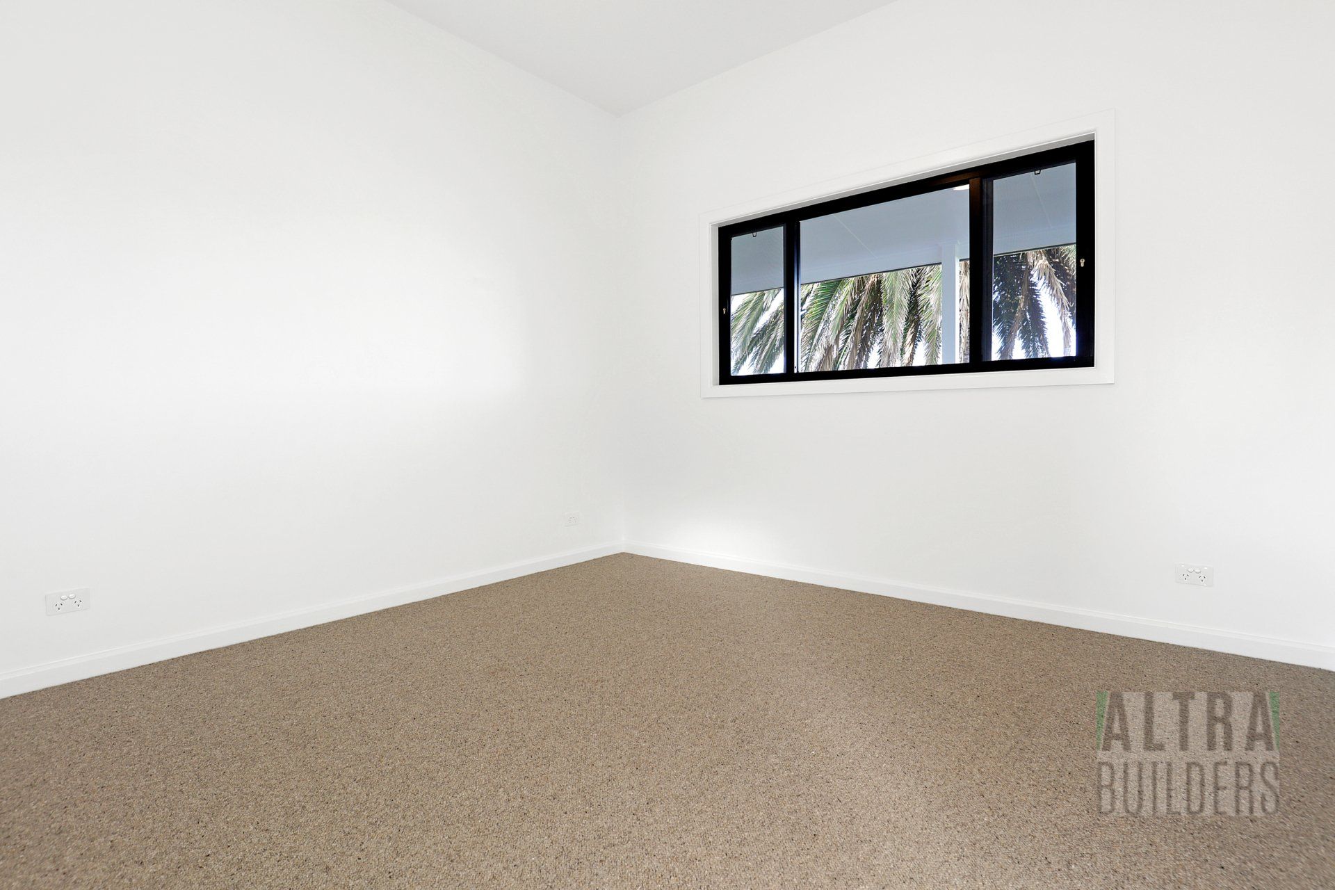 An empty room with a window and the word builders on the bottom