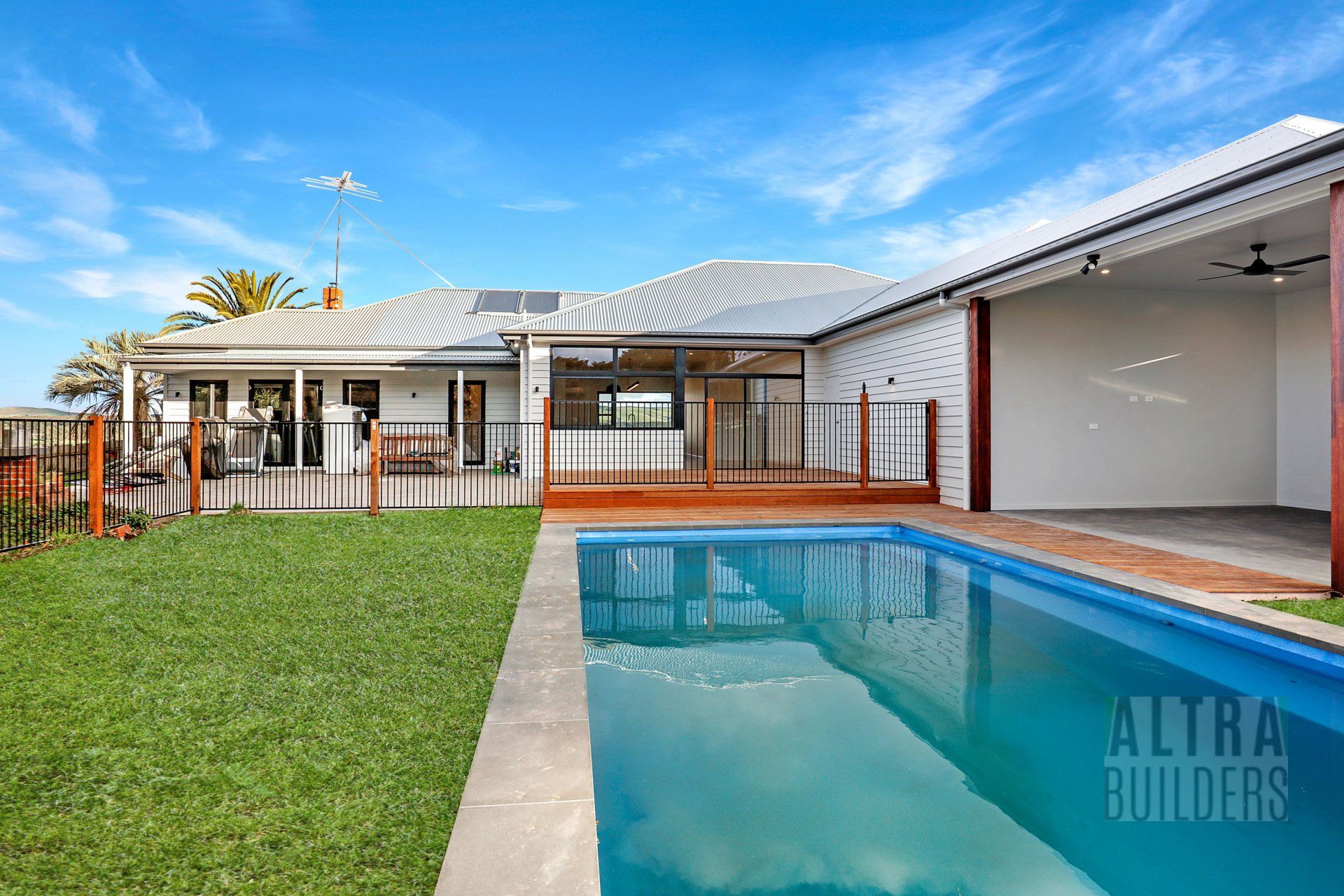 A house with a large swimming pool in the backyard.