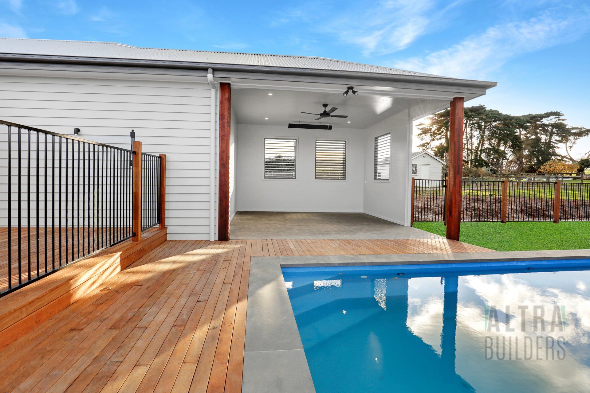 A house with a swimming pool and a wooden deck