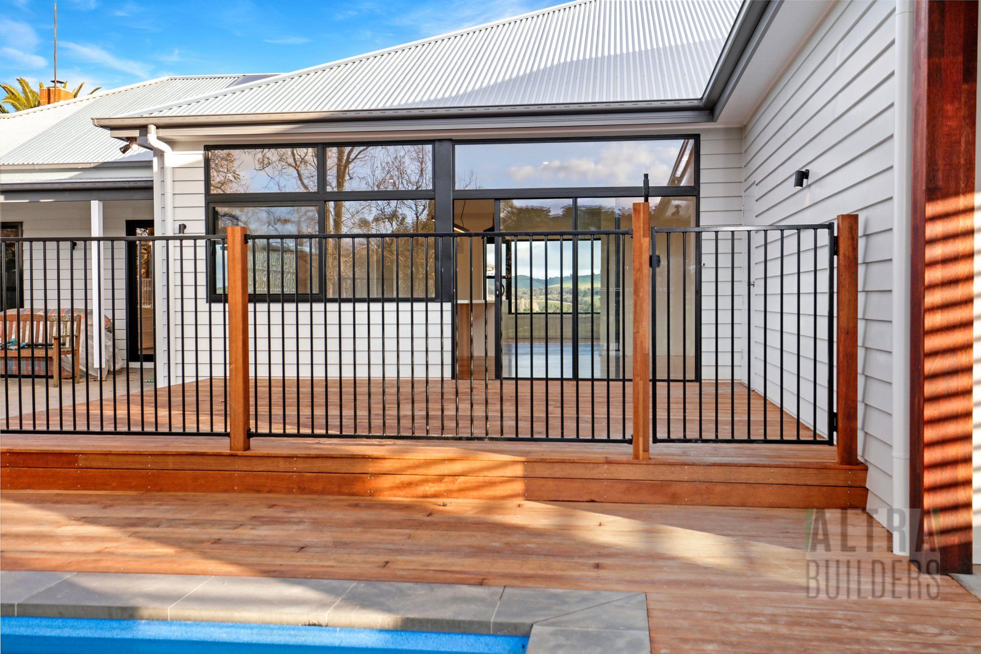 A house with a fence around it and a swimming pool.