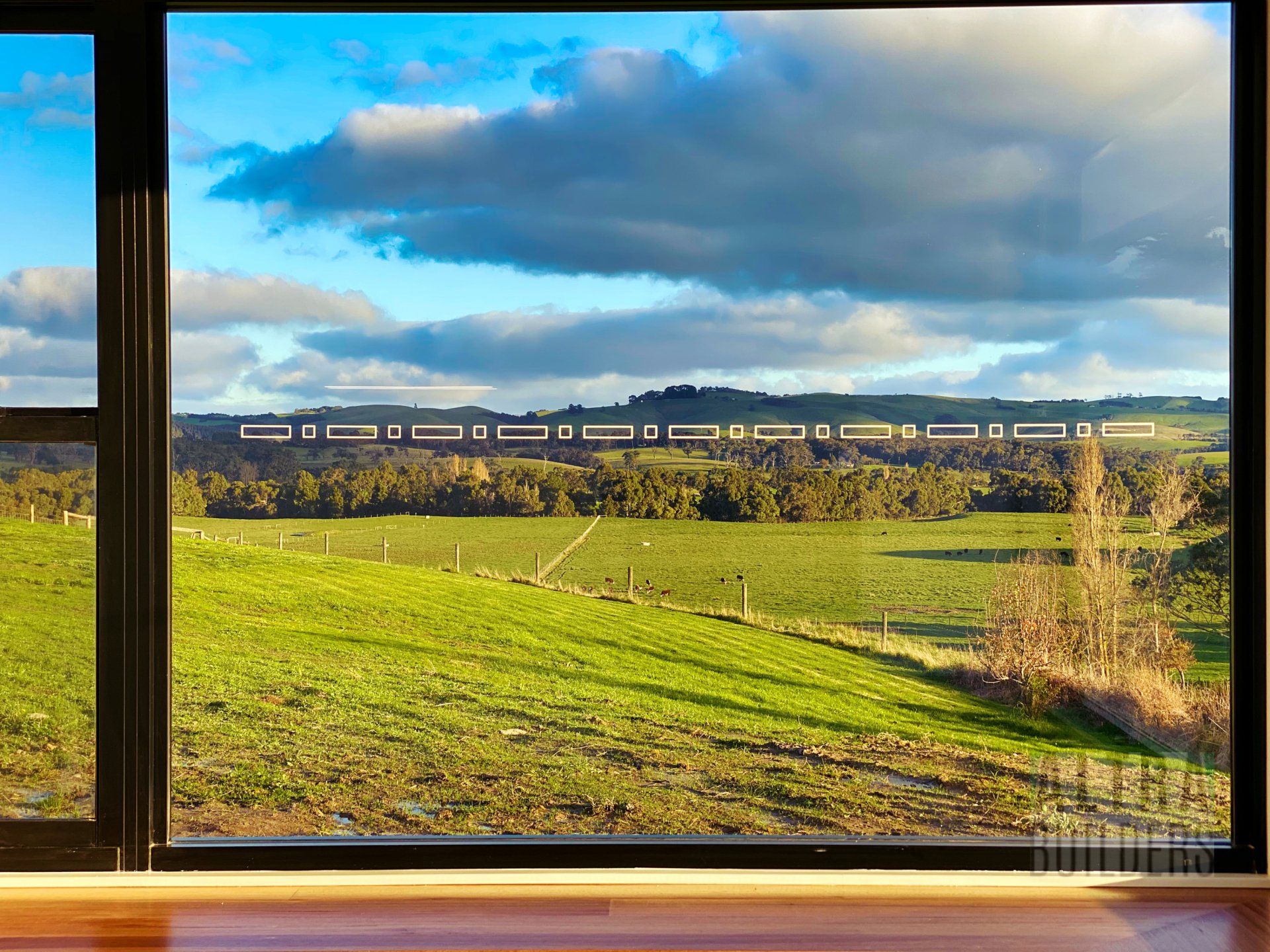 A window with a view of a grassy field
