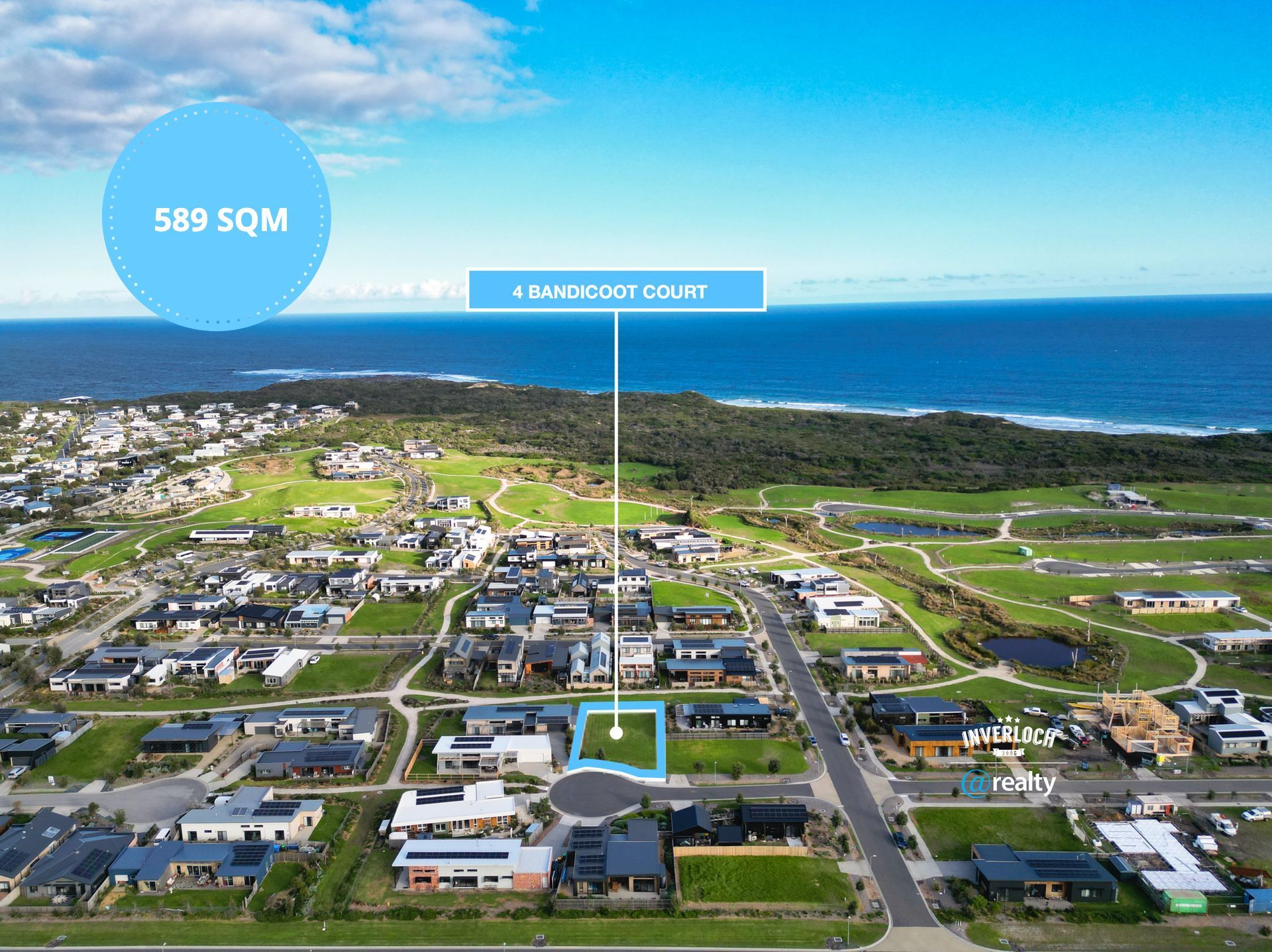 An aerial view of a residential area next to the ocean.