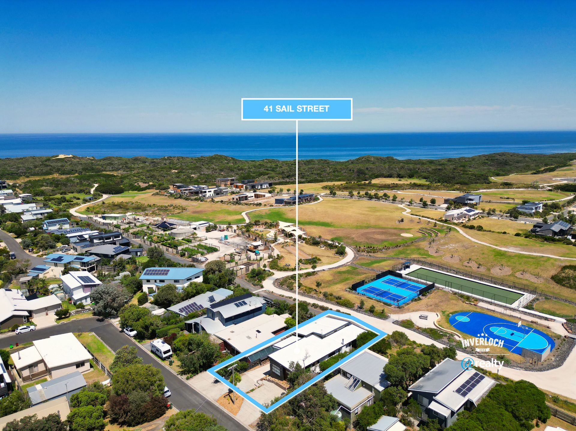 An aerial view of a residential area next to the ocean.