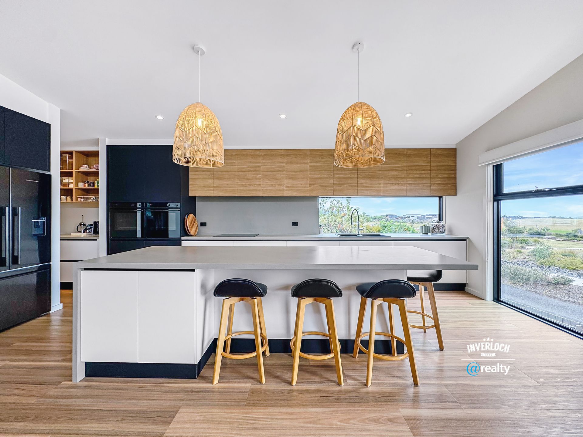 A kitchen with a large island and stools