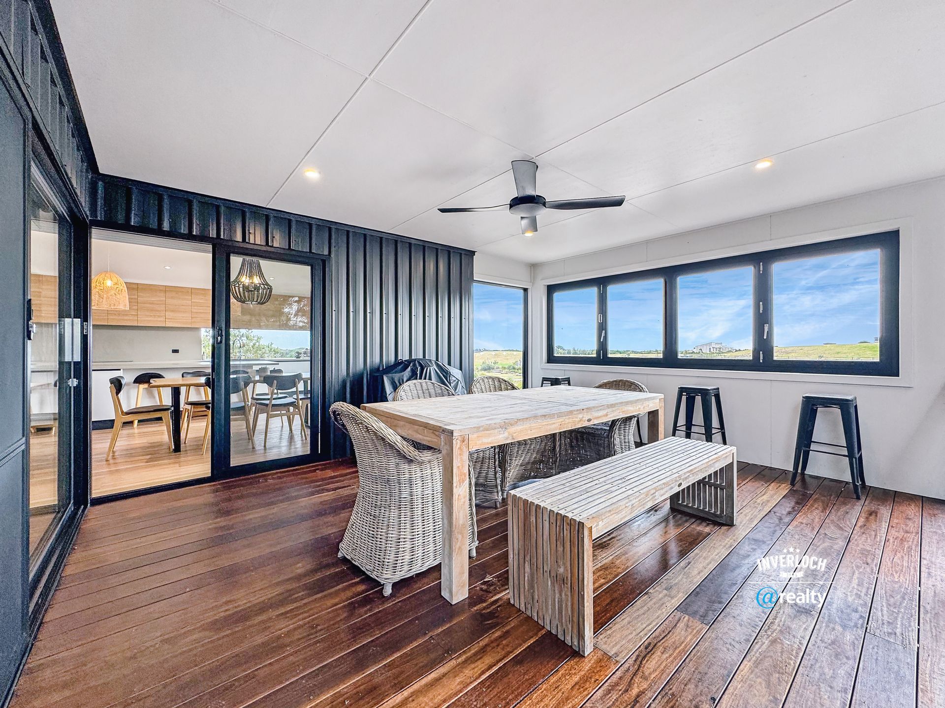 A dining room with a table and chairs and a bench.