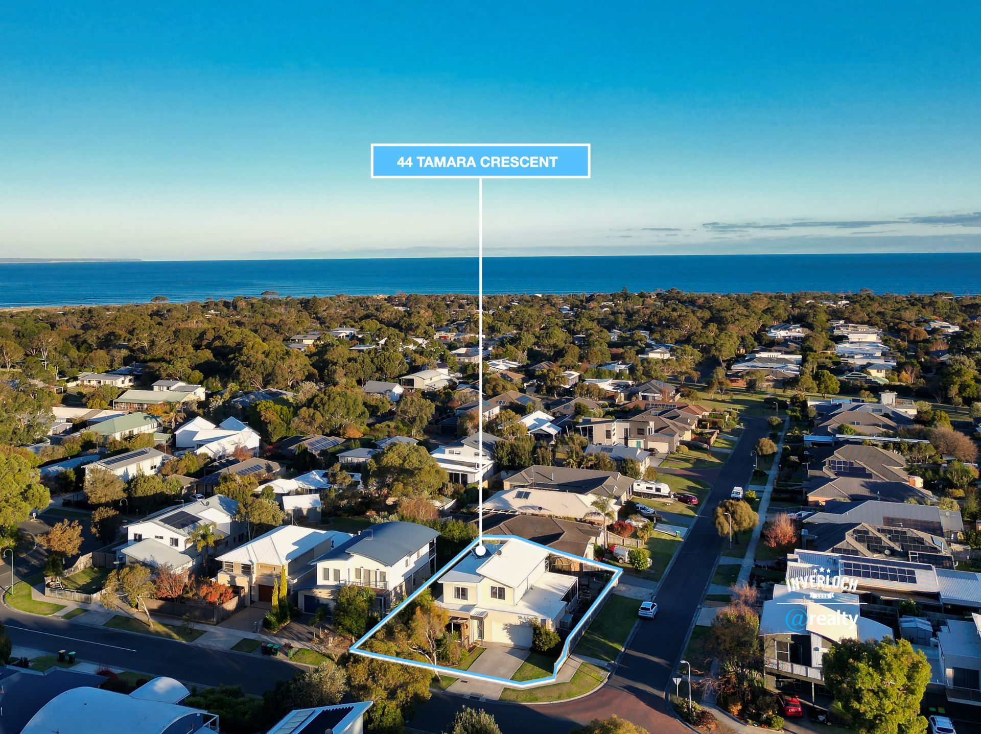 An aerial view of a residential area near the ocean