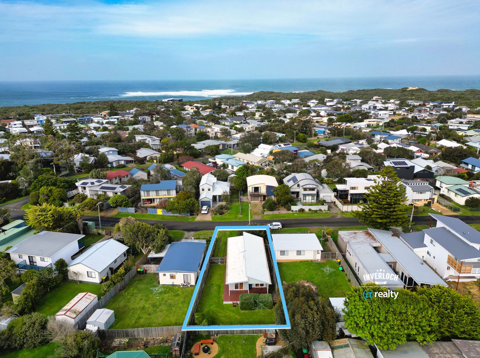 An aerial view of a residential area with a house in the middle.