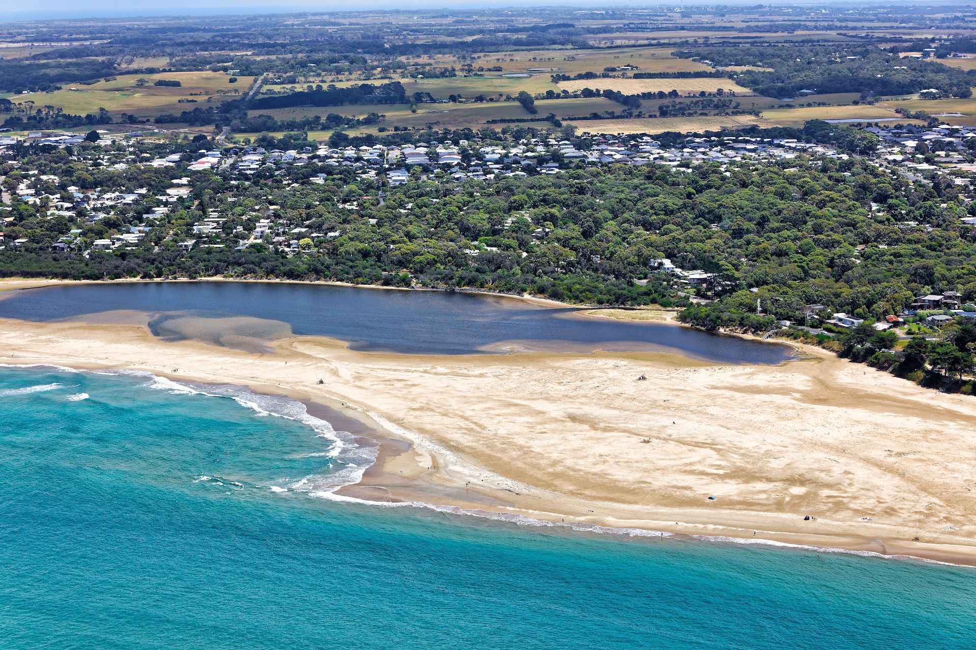 An aerial view of a beach with a lake in the middle