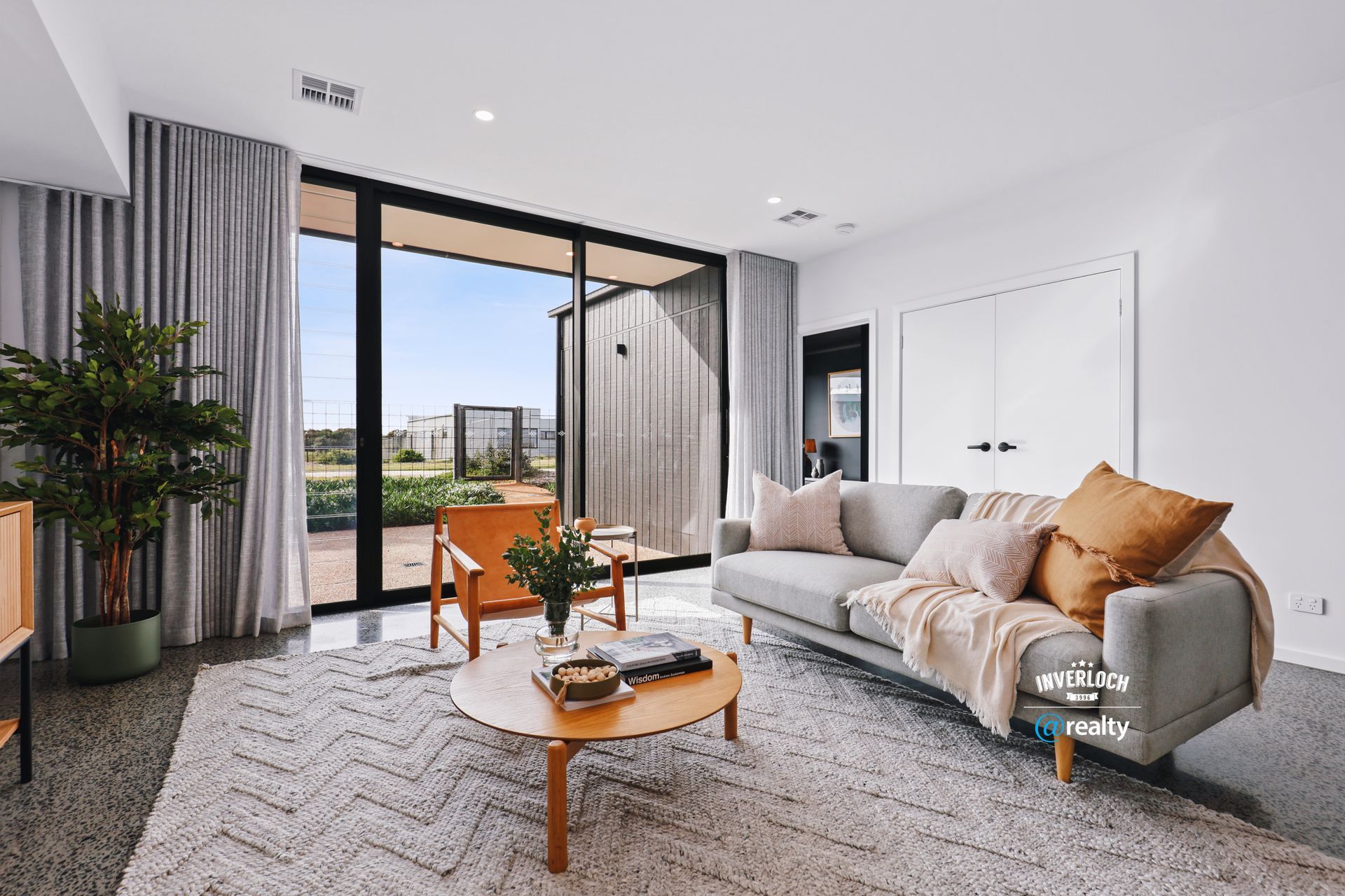 A living room with a couch , chairs , and a coffee table.