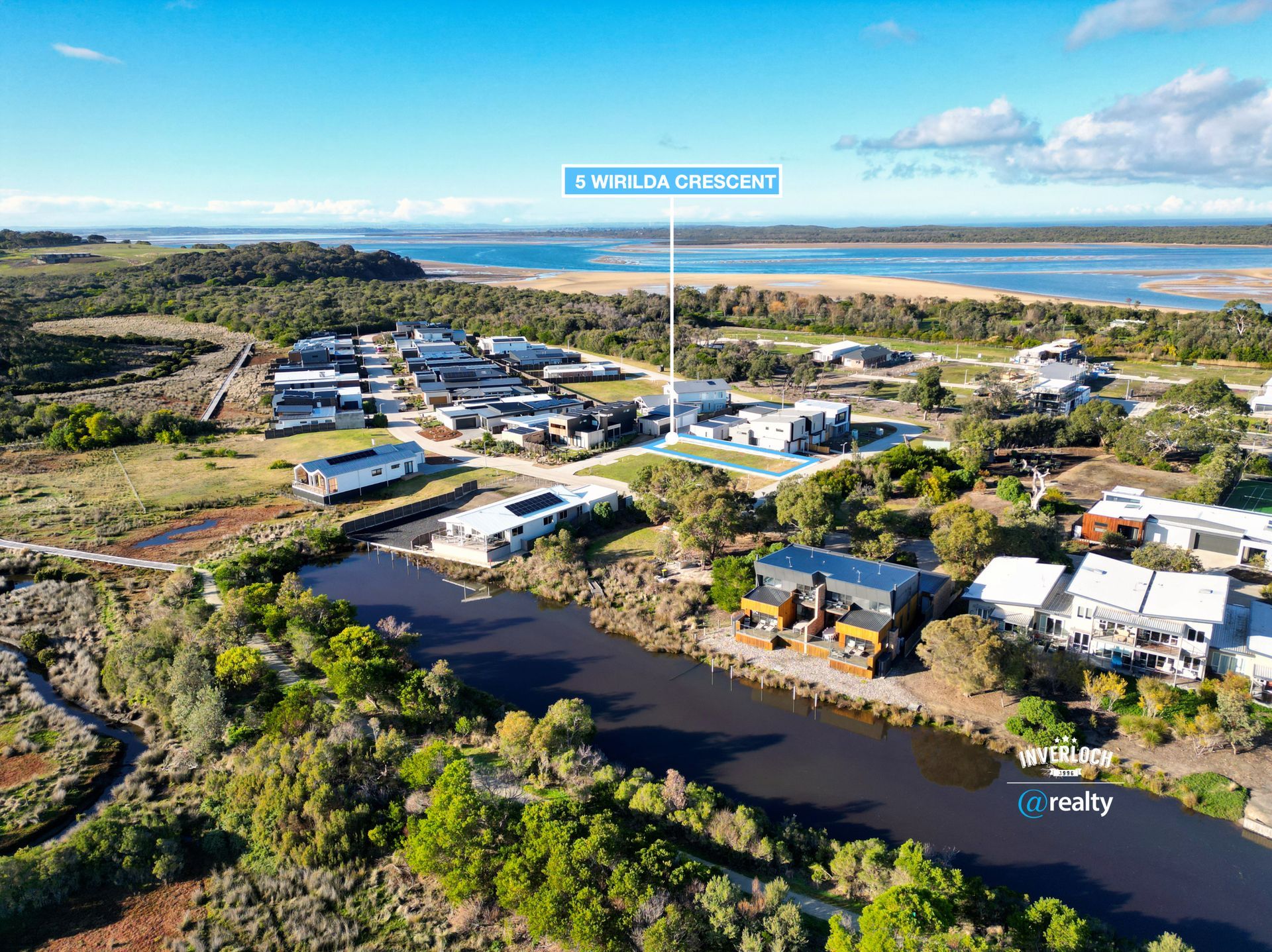 An aerial view of a residential area next to a body of water.
